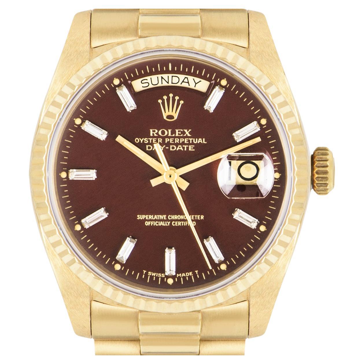 A rare yellow gold Day-Date by Rolex. Featuring the highly sought out and collectable oxblood Stella dial, which features emerald cut diamond hour markers and a fixed yellow gold fluted bezel.

Fitted with a sapphire glass and powered by a