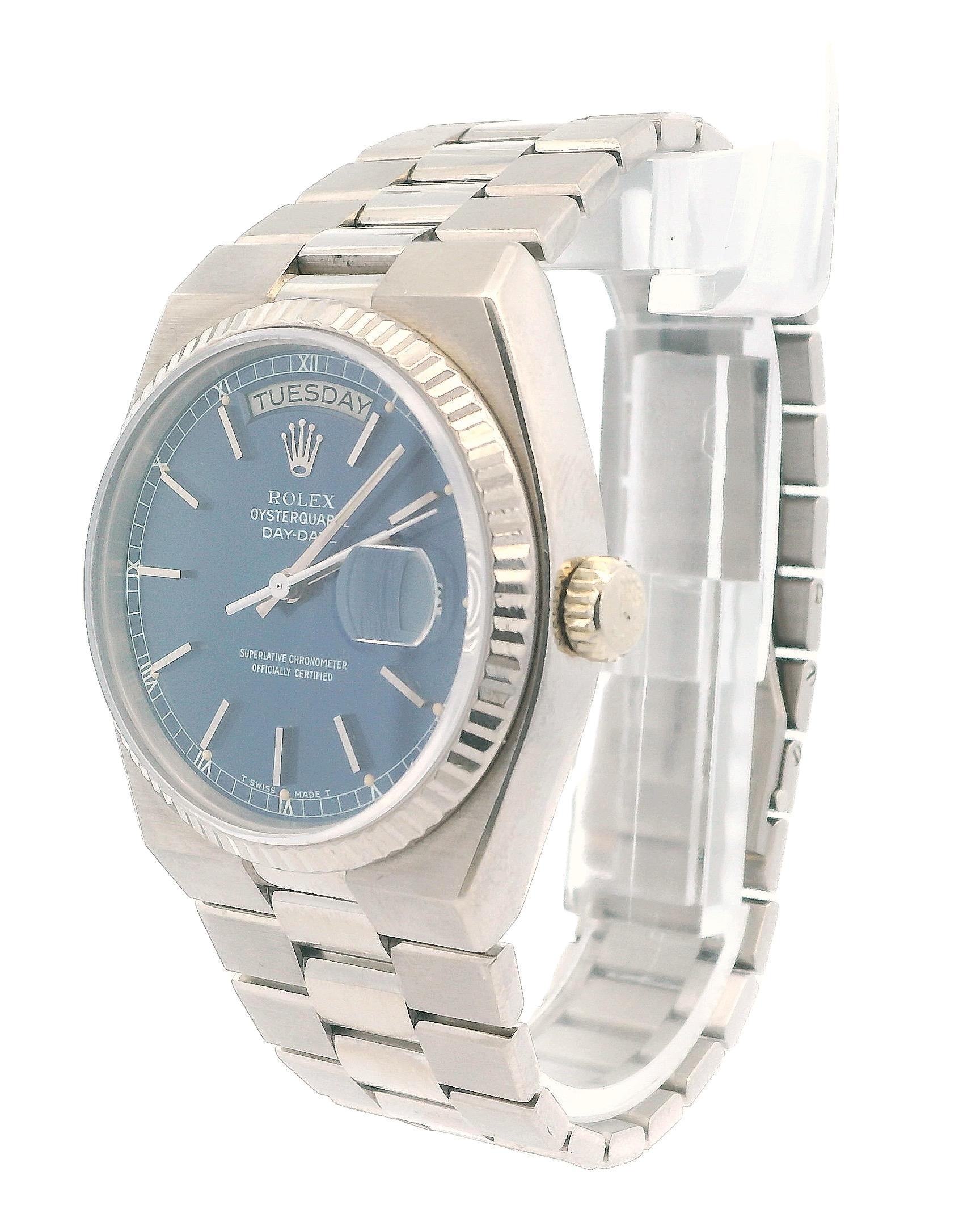 Rolex Oysterquartz President Day-Date Herrenuhr. Dieser Zeitmesser verfügt über ein 36-mm-Gehäuse aus 18 Karat Weißgold und eine geriffelte Lünette aus 18 Karat Weißgold. Das blaue Zifferblatt wird von leuchtenden Weißgoldzeigern und Indexen