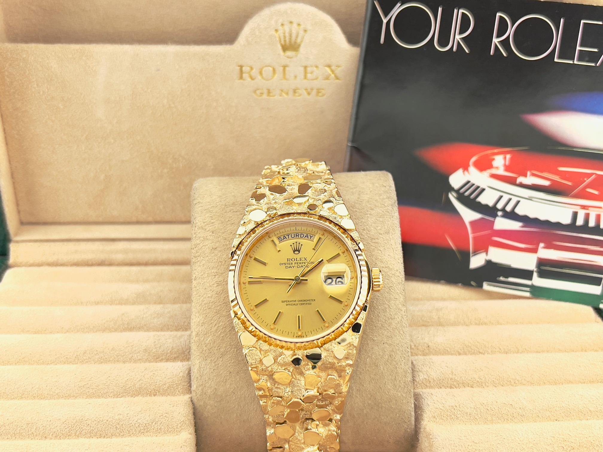 Style Number: 18038

Serial: 6128***

Year: 1979

Model: Rolex Day-Date 

Case Material: 18K Yellow Gold

Band: Custom 14K Yellow Gold Nugget Band

Bezel: 18K Yellow Gold

Dial: Champagne

Face: Sapphire Crystal

Case Size: 36mm

Wrist Size: 7.75