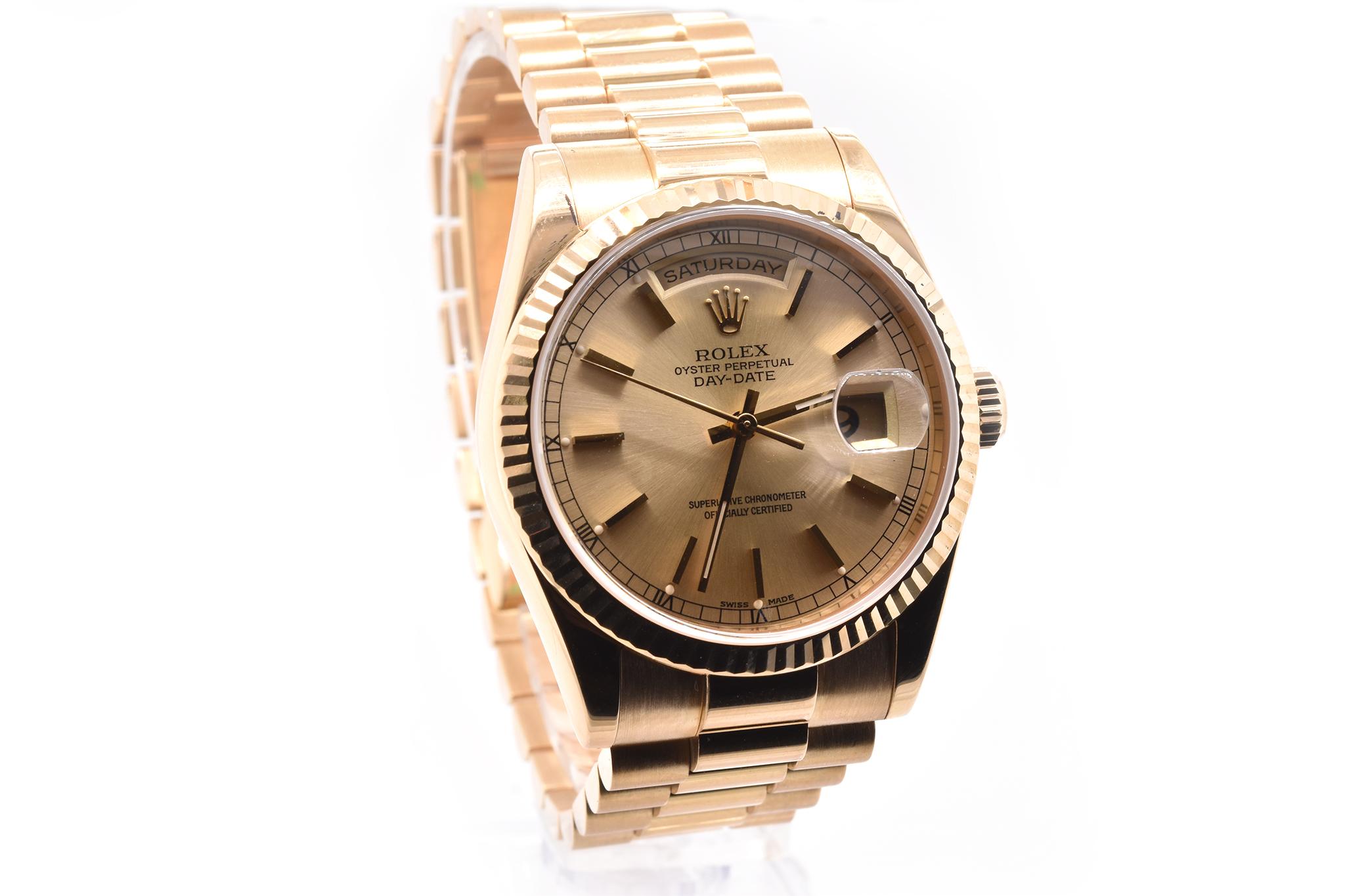 Brand: Rolex
Movement: automatic
Function: seconds, minutes, hours, day, date
Case: 36mm 18k yellow gold case, fluted bezel, scratch resistant sapphire crystal
Band: 18k yellow gold Rolex President bracelet
Dial: factory champagne dial with gold