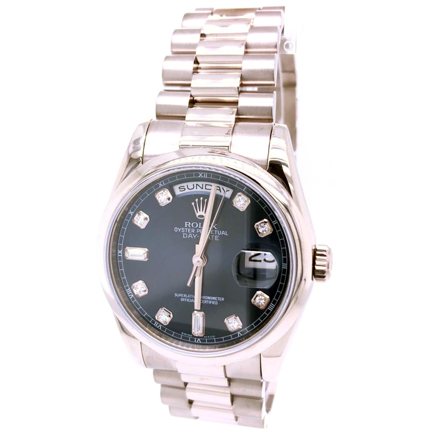 This Rolex Day-Date White Gold Diamond Automatic Bracelet Oyster Case 36mm case height 12mm. Blue/black gradient dial with 8 brilliant hour markers and 2 diamond baguettes at 6 and 9 o'clock and white gold hands and cranked minute track. Movement
