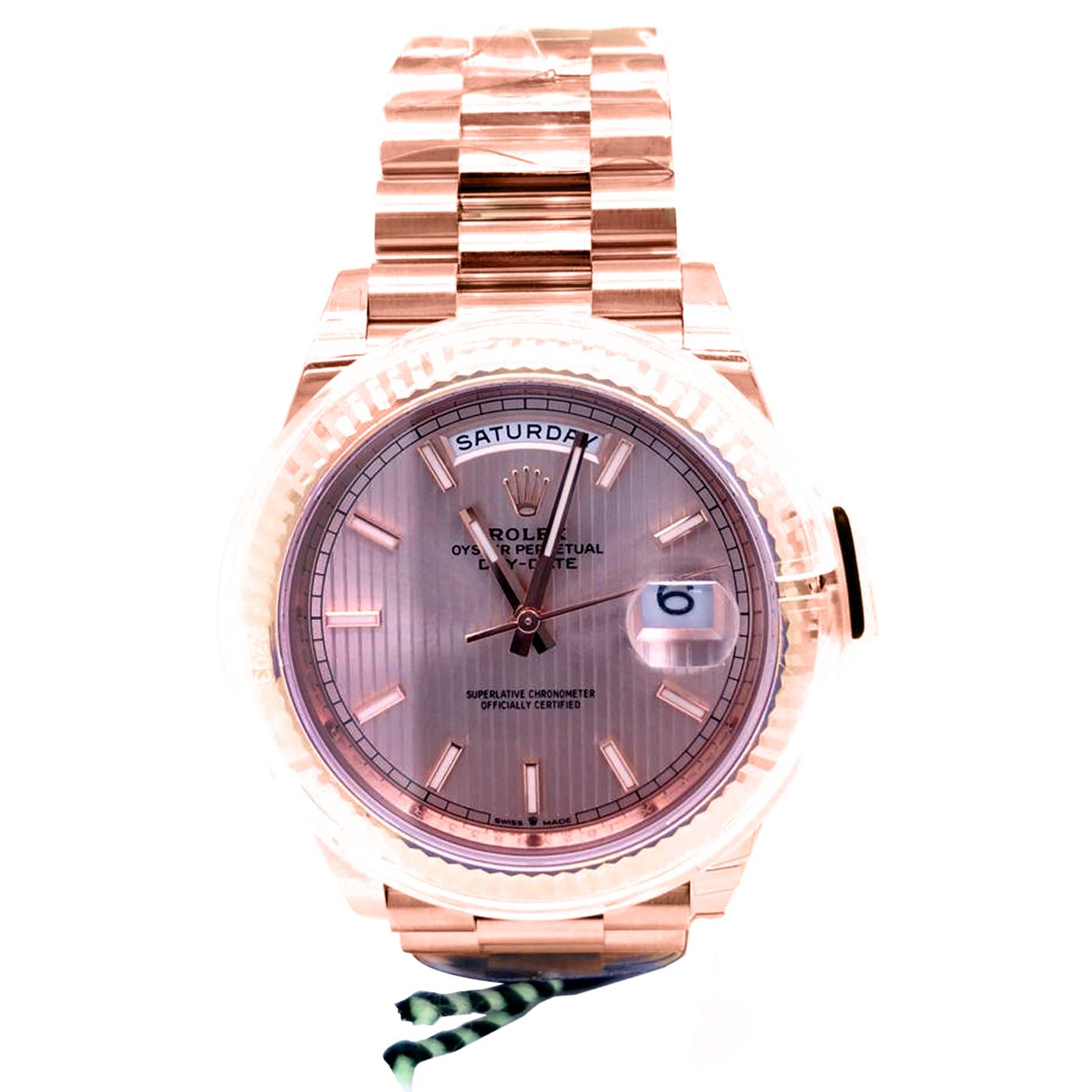 The Oyster Perpetual Day-Date 40 in 18 ct Everose gold with chocolate, diamond-set dial, fluted bezel, and a President bracelet. The Day-Date was the first watch to indicate the day of the week spelled out in full when it was first presented in