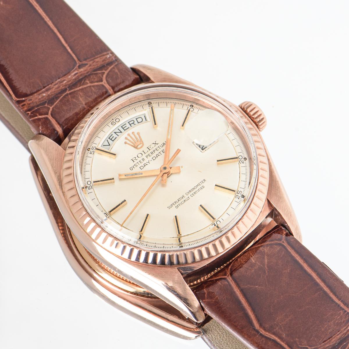 A vintage 36mm Day-Date by Rolex in rose gold which is somewhat rare. Features a silver dial and fluted bezel which is an iconic Day-Date feature. The generic brown leather strap comes with an original gold plated pin buckle. Fitted with plastic