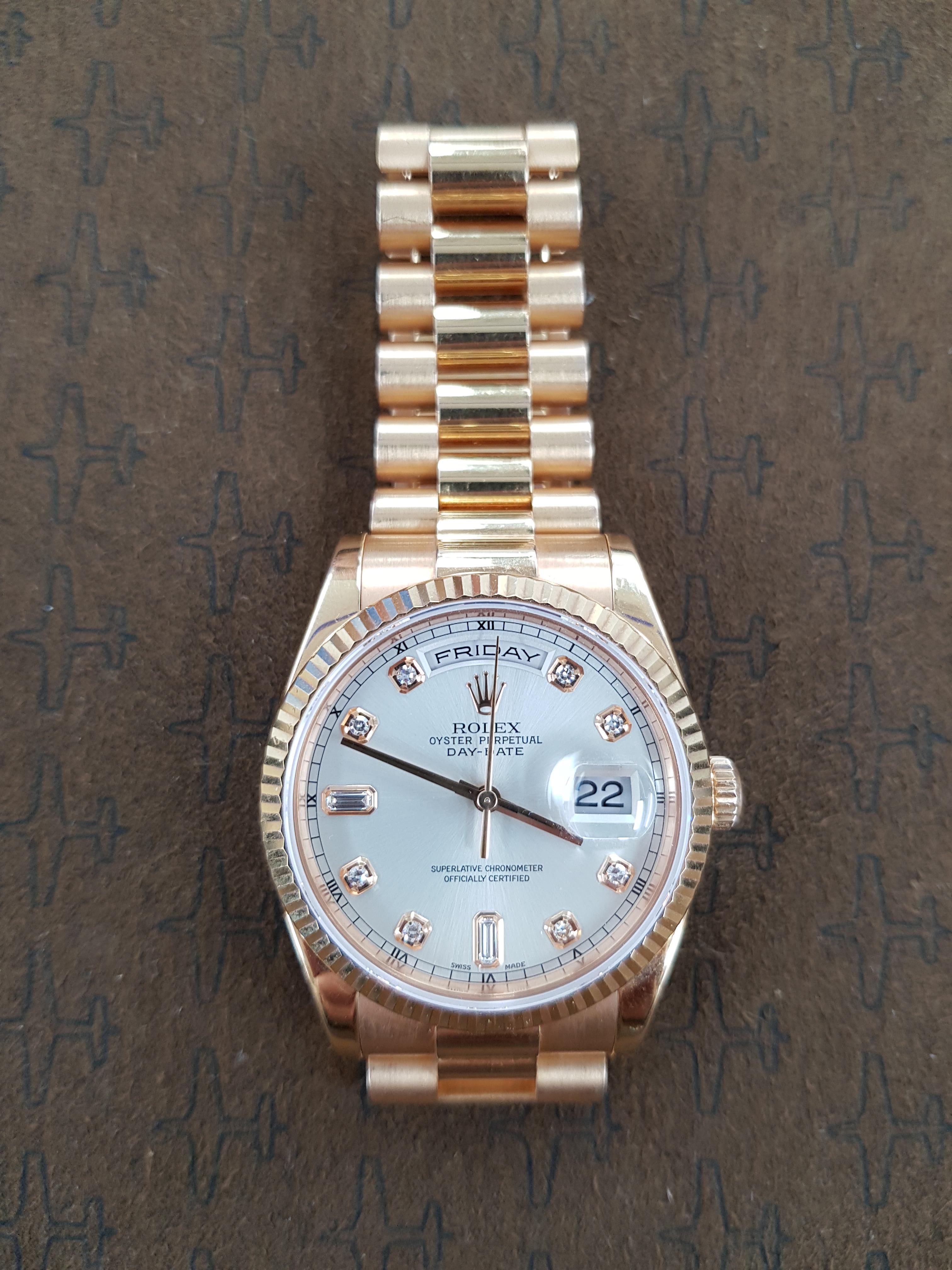 This 36mm dial, rose gold, Rolex Day Date comes with full Rolex certification.  It has been fitted with new (Rolex manufactured) links and it contains a solid clasp.