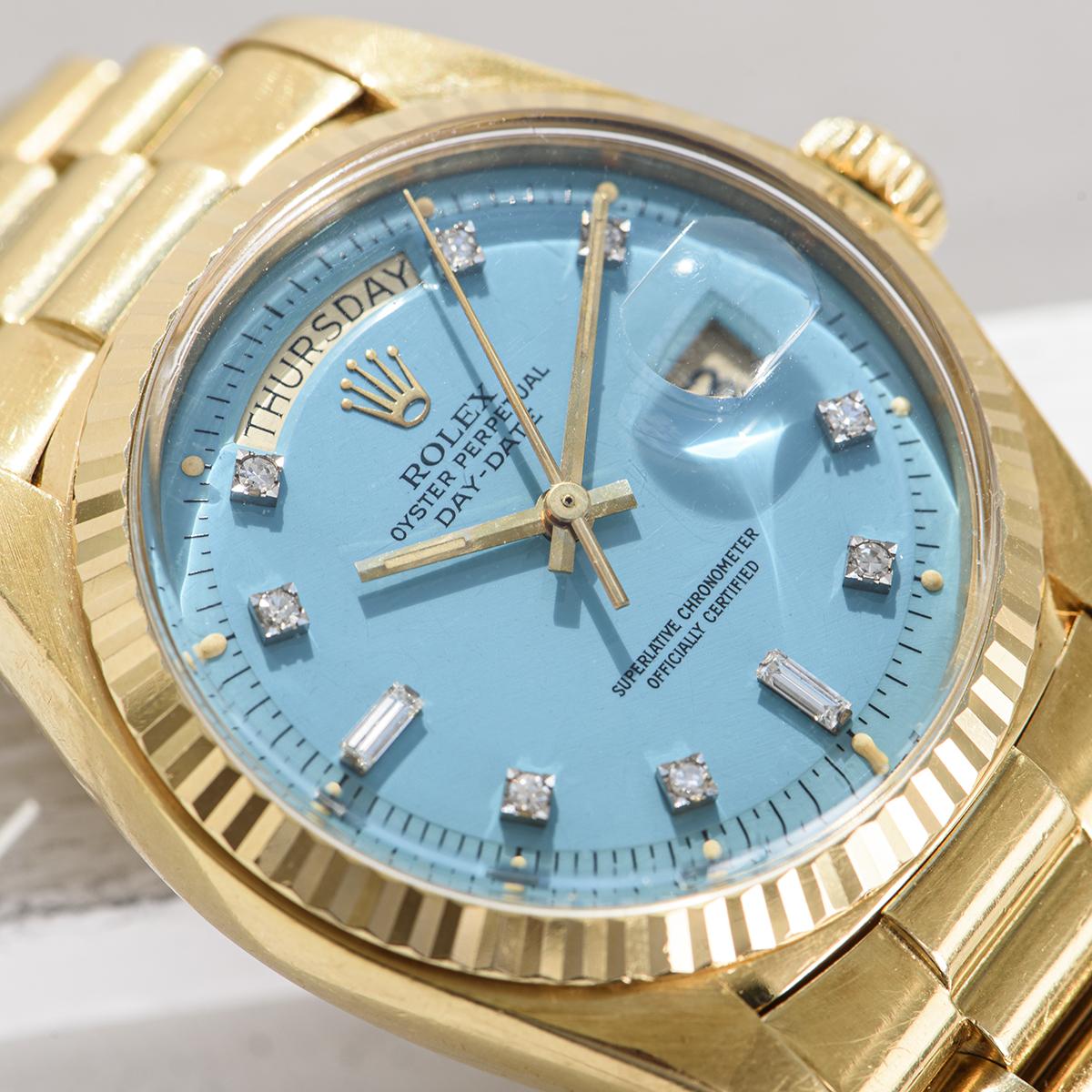 A vintage 36mm Day-Date in yellow gold by Rolex, featuring a rare turquoise Stella dial set with 2 baguette-cut and 8 round brilliant cut diamond hour markers. The fluted bezel, president bracelet and concealed folding Crownclasp are distinctive