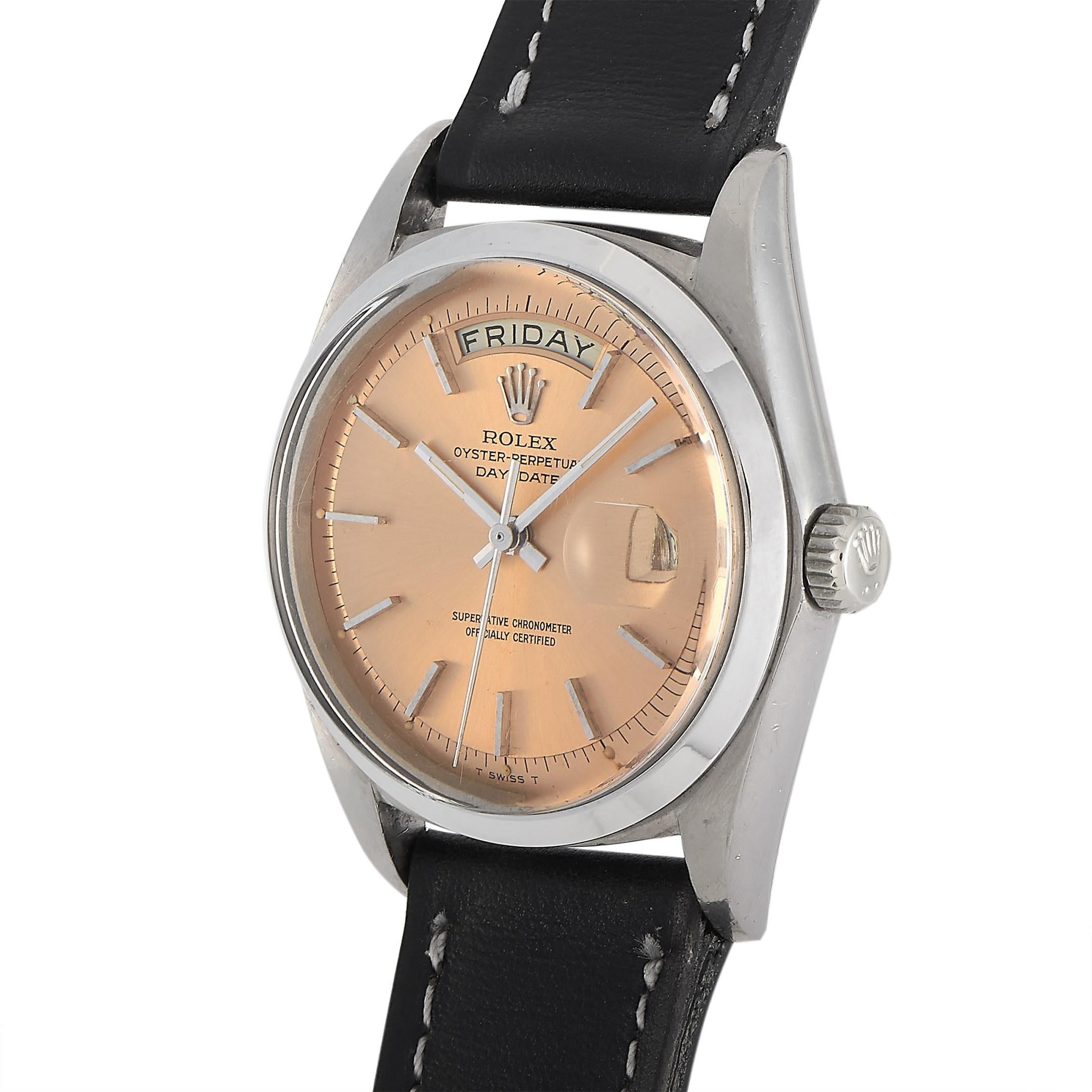 The Rolex Day-Date Watch, reference number 1802, is a functional timepiece that will never go out of style. 

This watch begins with a 36mm case crafted from shimmering 18K white gold, which contrasts beautifully against the black leather strap. On