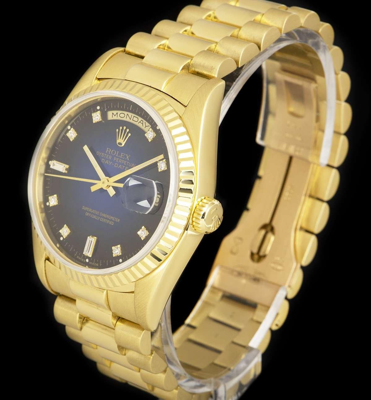 An 18k Yellow Gold Oyster Perpetual Day-Date Gents Wristwatch, blue vignette dial set with 8 applied round brilliant cut diamond hour markers and 2 baguette cut diamond hour markers, day aperture at 12 0'clock, date aperture at 3 0'clock, a fixed