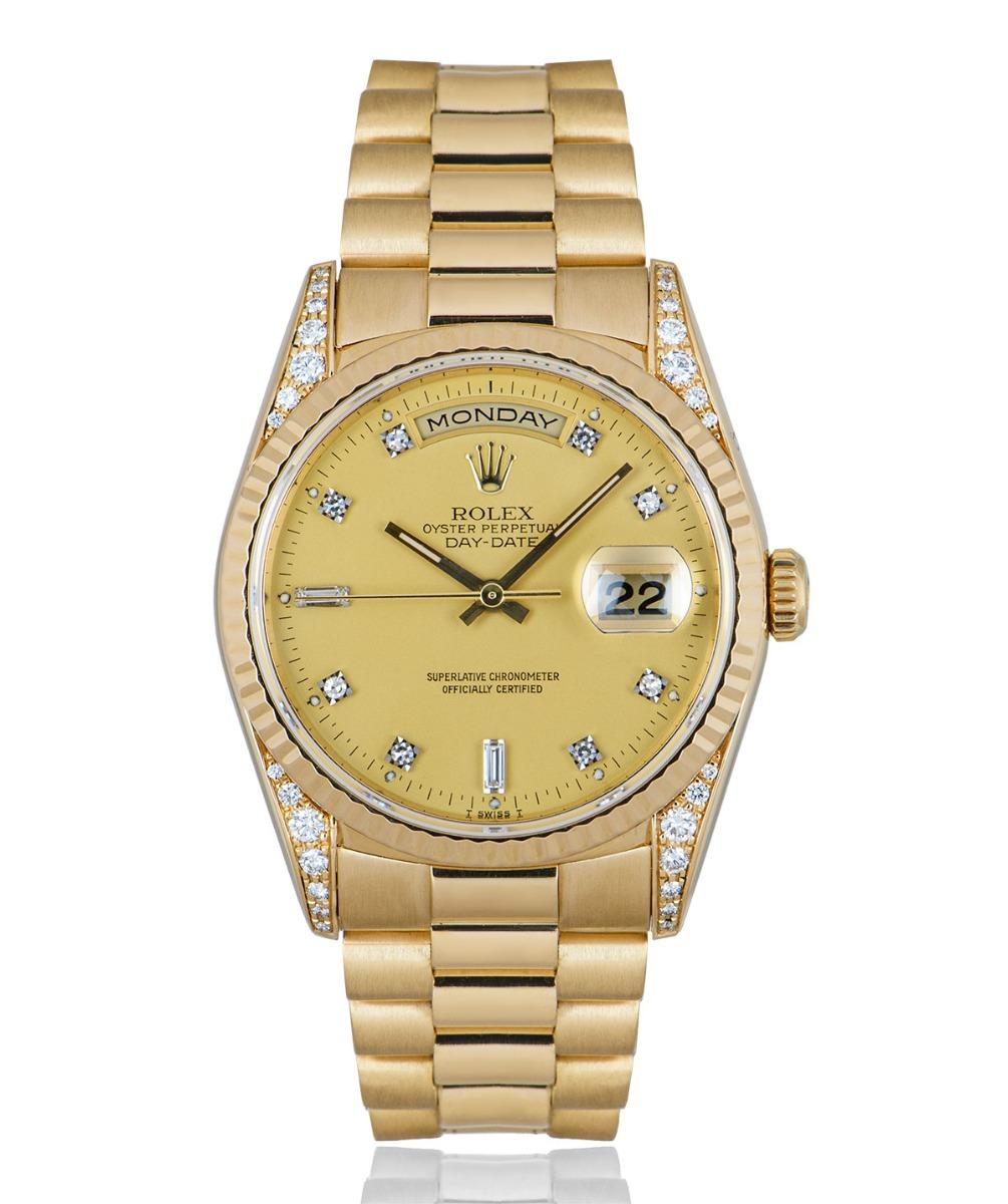 A 36 mm Day-Date in yellow gold from Rolex, features a champagne dial set with 2 baguette and 8 round brilliant cut diamond hour markers. The fluted bezel, president bracelet and concealed deployant clasp are synonymous with a Day-Date. Set with a