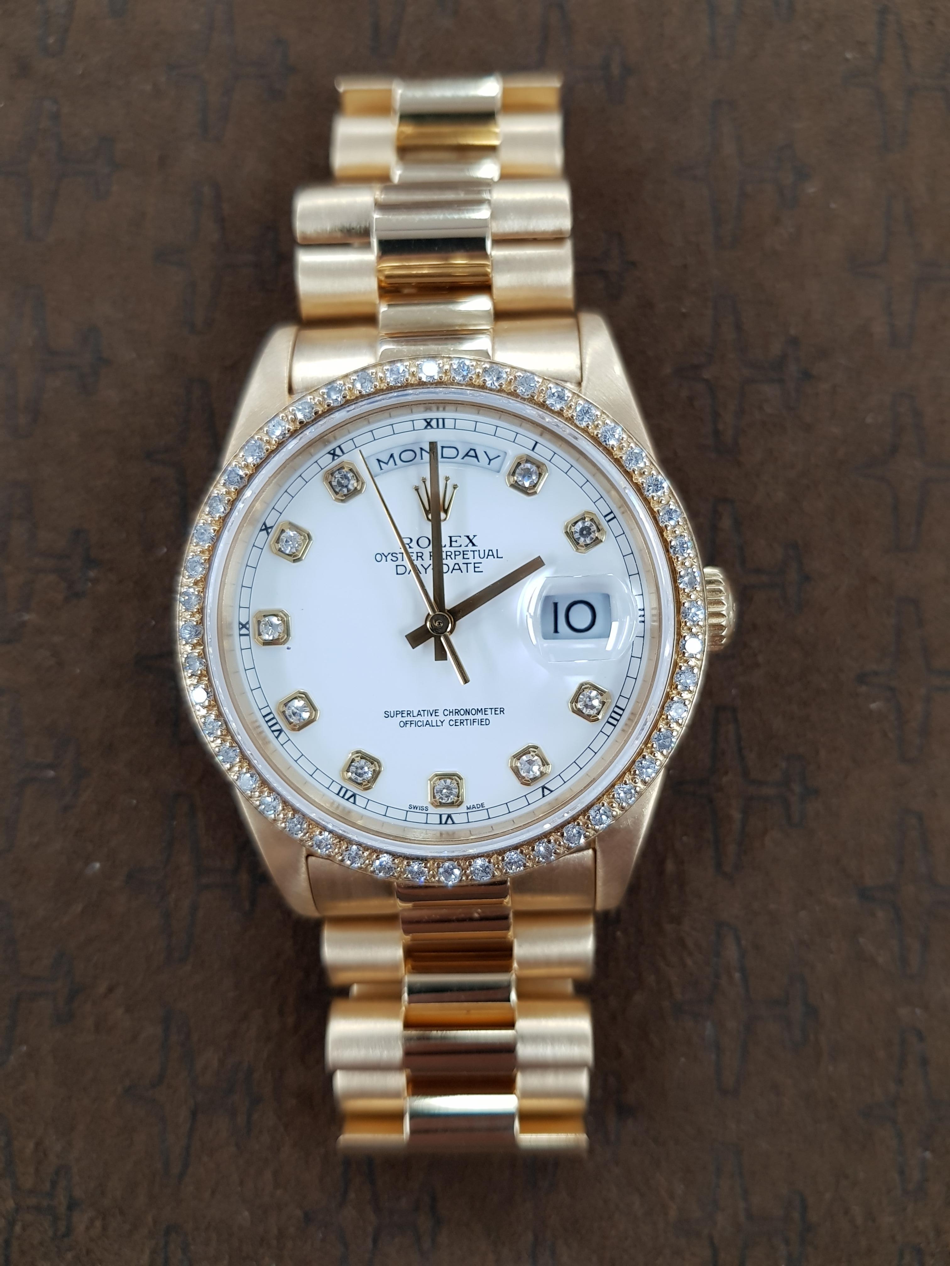 Rolex Day Date in yellow gold with a unique diamond bezel and 36mm dial.