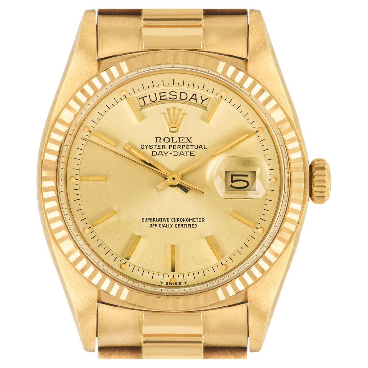 This unworn NOS Day-Date in 18k yellow gold by Rolex, features a champagne dial with applied hour markers and a fixed yellow gold fluted bezel. Fitted with a plastic glass, a self-winding automatic movement and a yellow gold president bracelet