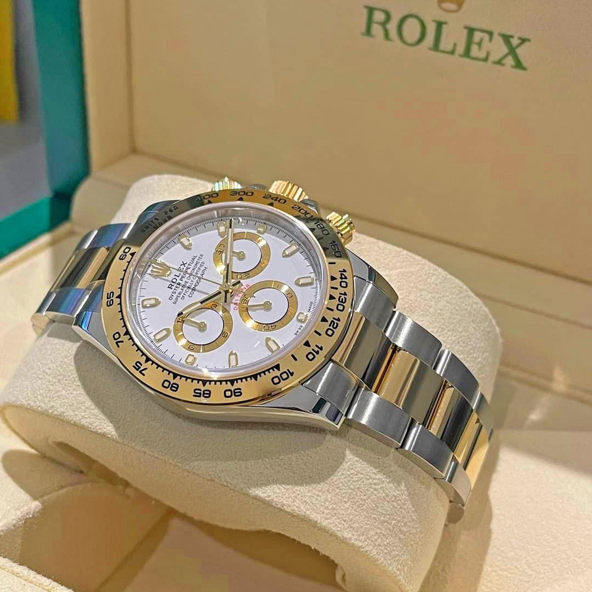 Rolex Cosmograph Daytona, 18k Yellow Gold and Stainless Steel 40mm watch, Reference 116503-0001. This model has White dial and white Champagne rimmed white sub-dials. Highly legible Chromalight display with long-lasting blue luminescence. Applied