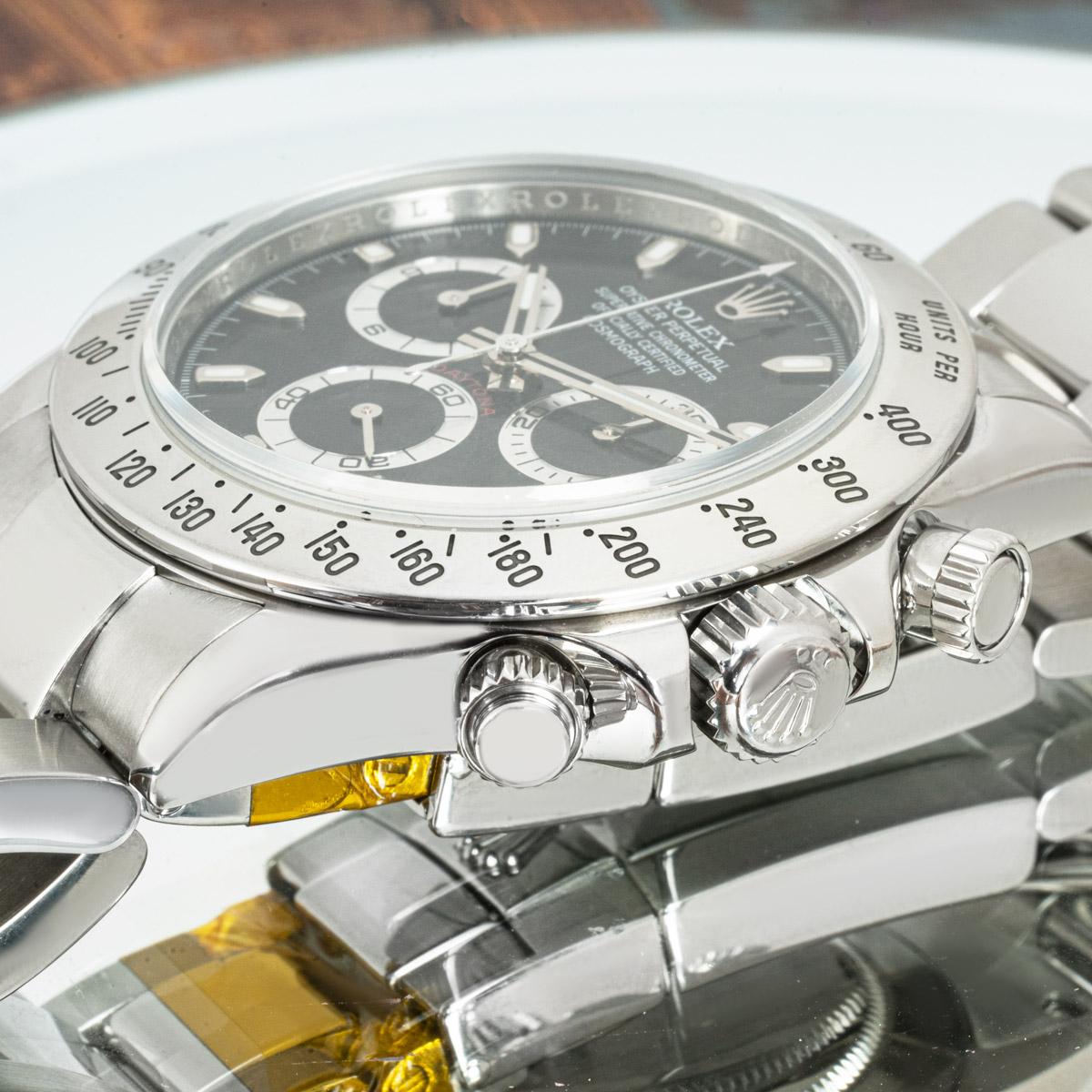 A stainless steel Cosmograph Daytona by Rolex. Featuring a black dial with an engraved tachymetric scale, three counters and pushers; the Daytona was designed to be the ultimate timing tool for endurance racing drivers.

The Oyster bracelet is