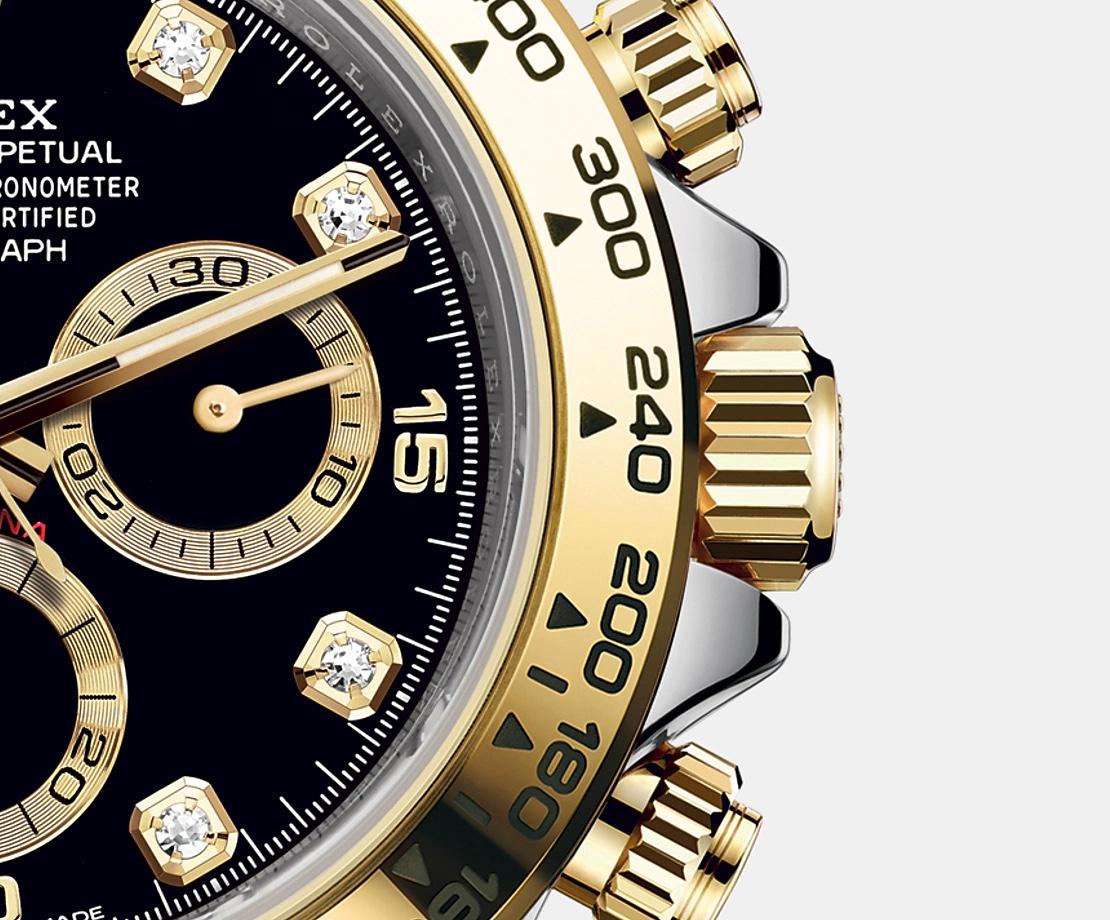 Rolex Cosmograph Daytona, 18k Yellow Gold and Stainless Steel 40mm watch. This model has Black dial with Black sub-dials with fine yellow gold rims. Hour markers are 10 Diamonds in 18k gold settings and polished 18k Yellow Gold hands - hour and
