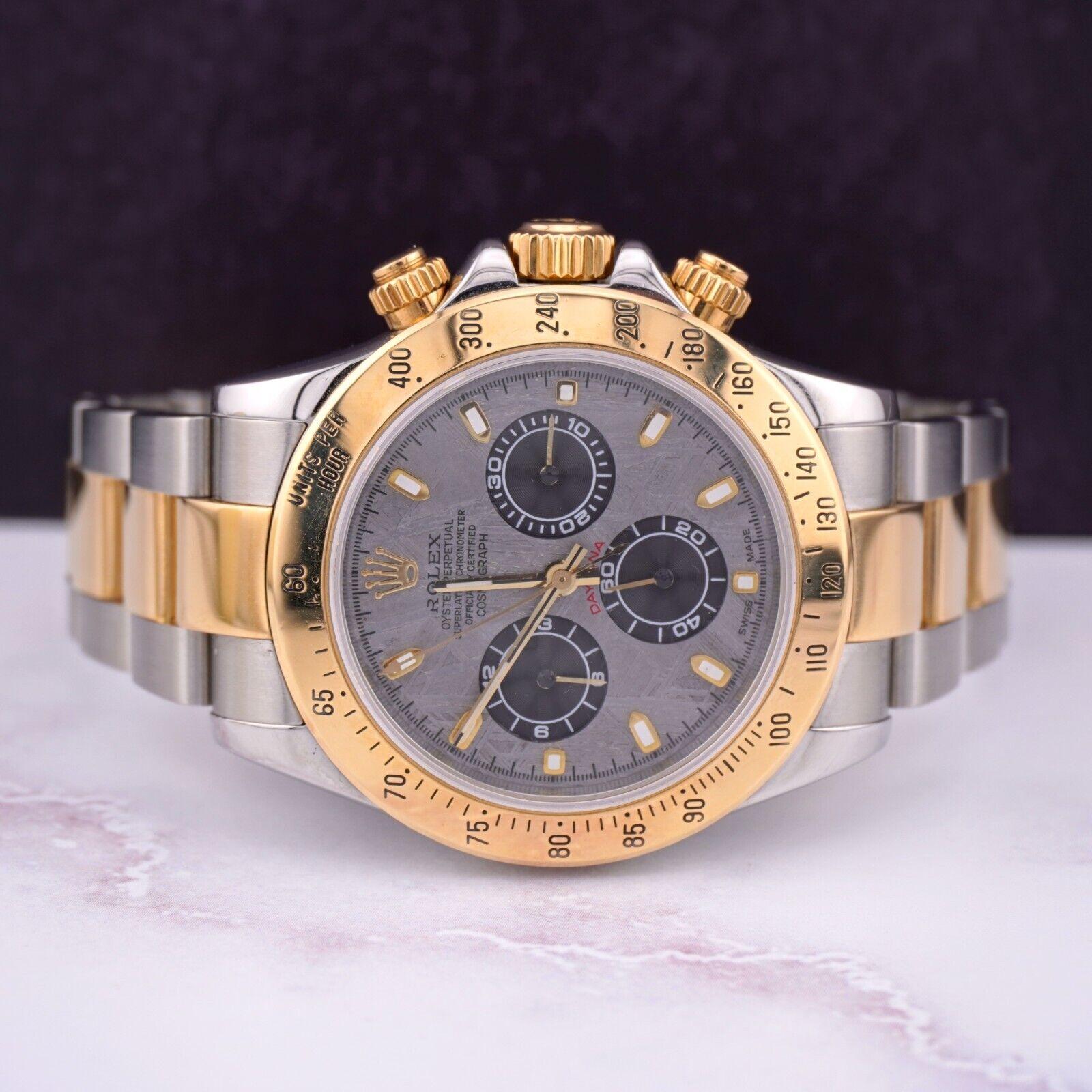 Rolex Daytona 40mm Watch. A Pre-owned watch w/ Gift Box. Watch is 100% Authentic and Comes with Authenticity Card. Watch Reference is 116523 and is in Excellent Condition (See Pictures). The dial color is Meteorite and material is 18k yellow gold