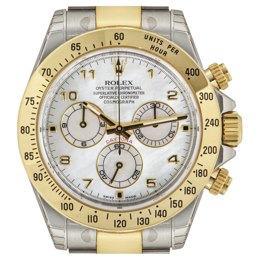 An unworn NOS Daytona in Oystersteel and yellow gold by Rolex, features a mother of pearl dial with Arabic numbers. Featuring an engraved tachymetric scale, three counters and pushers, the Daytona was designed to be the ultimate timing tool for