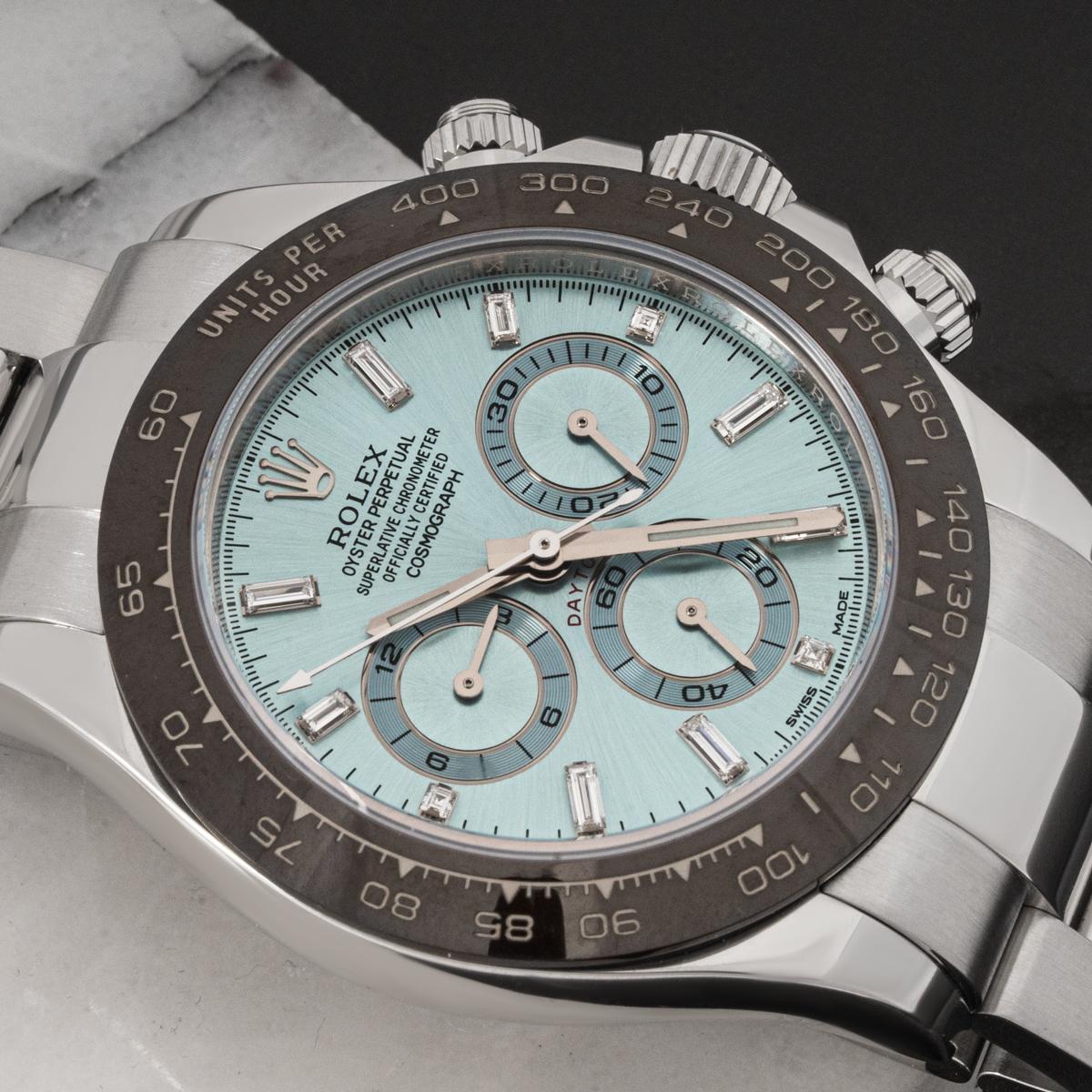 This platinum Daytona by Rolex is in mint condition. Features an ice blue dial which Rolex only use on platinum models. The dial itself is diamond set. With its tachymetric scale on the chestnut brown ceramic bezel, three snailed counters and three