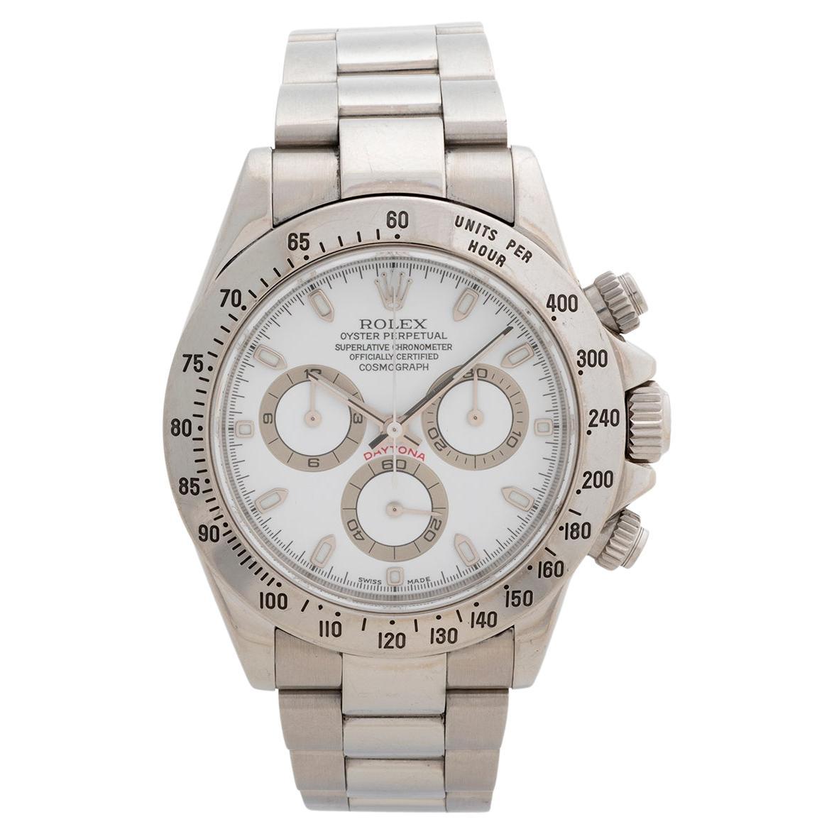 Our Rolex Daytona reference 116520 features a stainless steel case with stainless steel bracelet with flip lock clasp and features a white dial. A complete set, comprising inner and outer box, with 116520 and white dot stickers to the outer box,