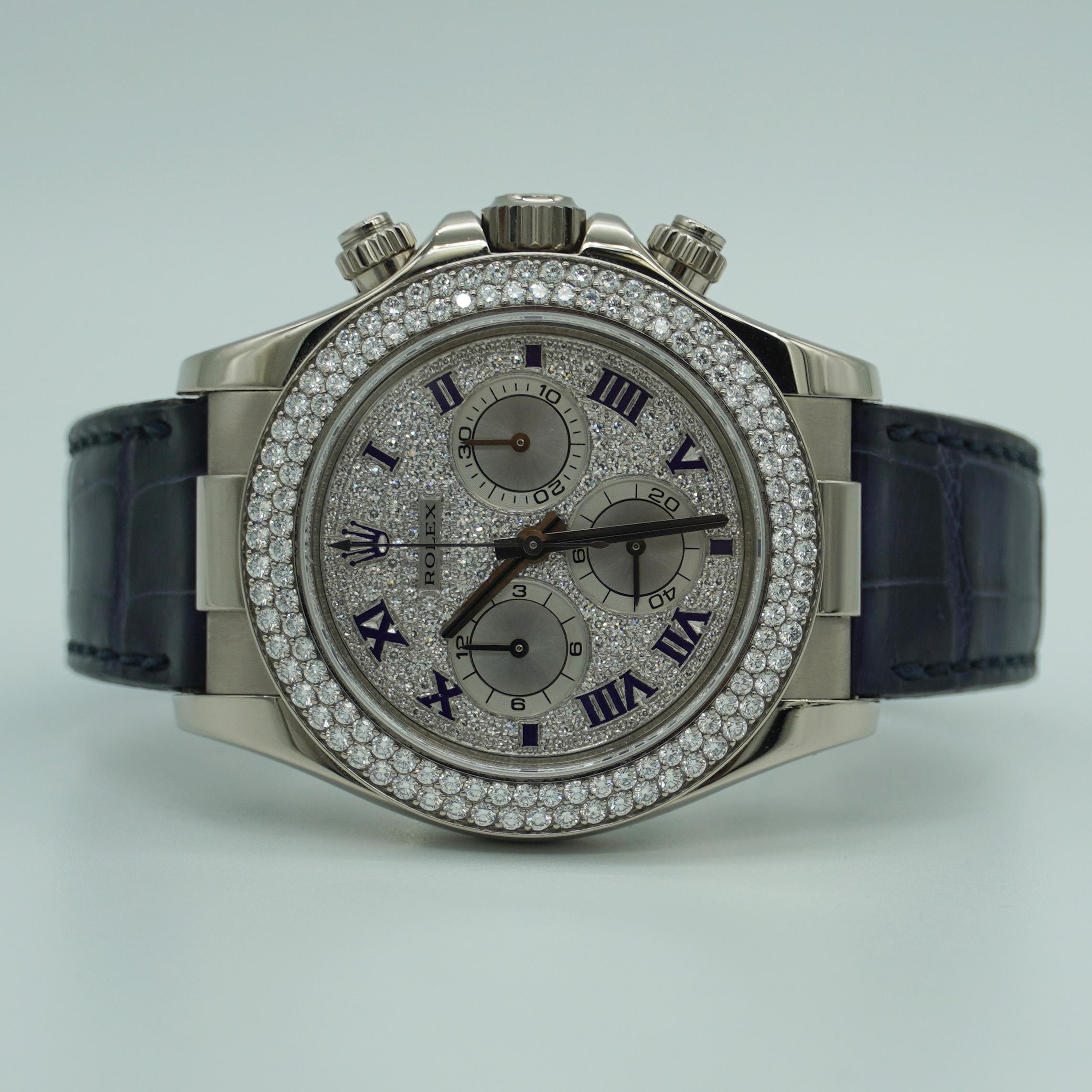 Rolex Daytona, 116589 40mm 18k White Gold Factory Diamond Dial. The Timepiece is powered by an automatic movement and features: 18k White Gold round case and clasp, and two-piece Alligator Navy Blue leather strap. Fixed Diamond Bezel. Pave diamond