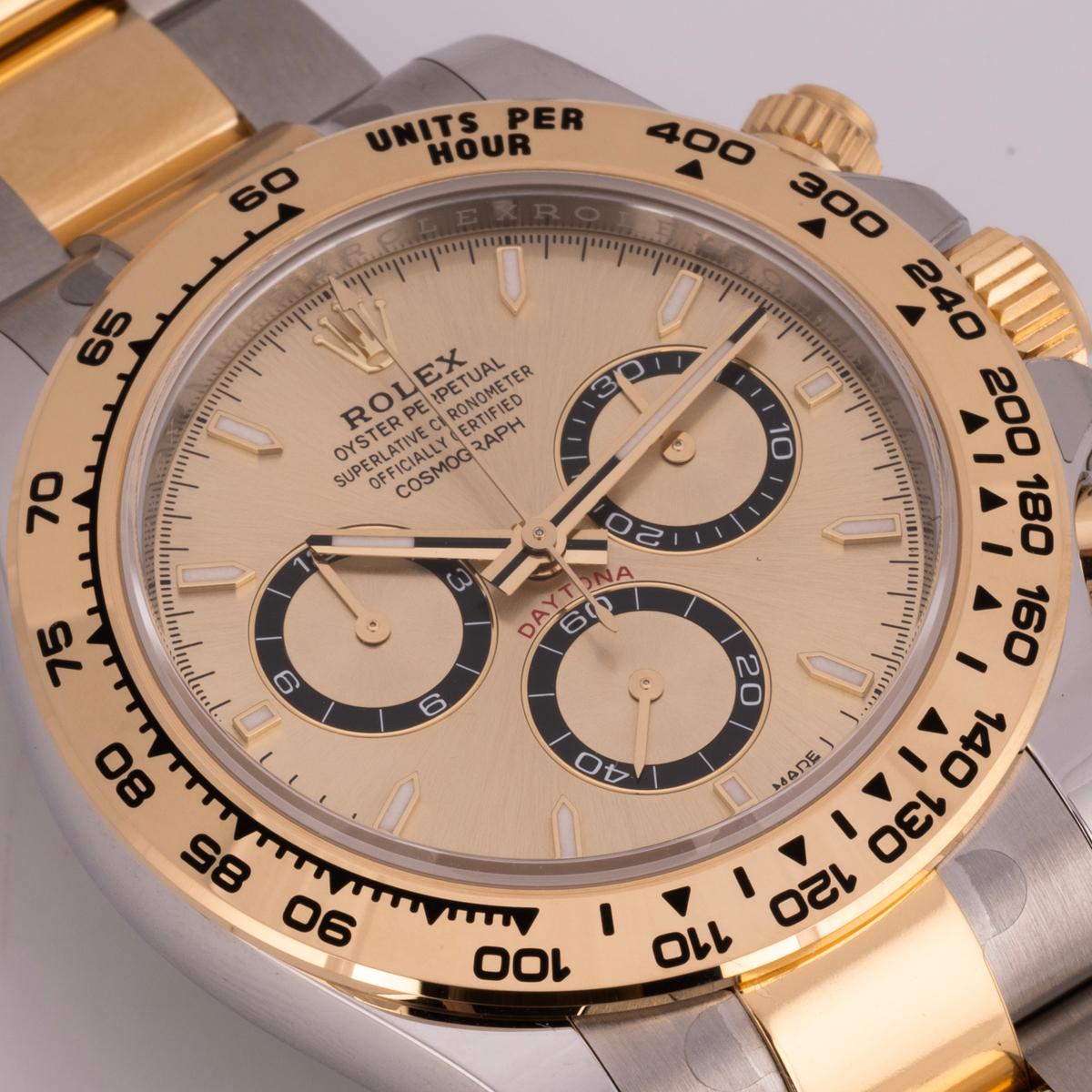 An unworn Daytona from Rolex in Oystersteel and yellow gold. Features a golden dial with applied hour markers. With an engraved tachymetric scale, three counters, and pushers, the Daytona was designed to be the ultimate timing tool for endurance