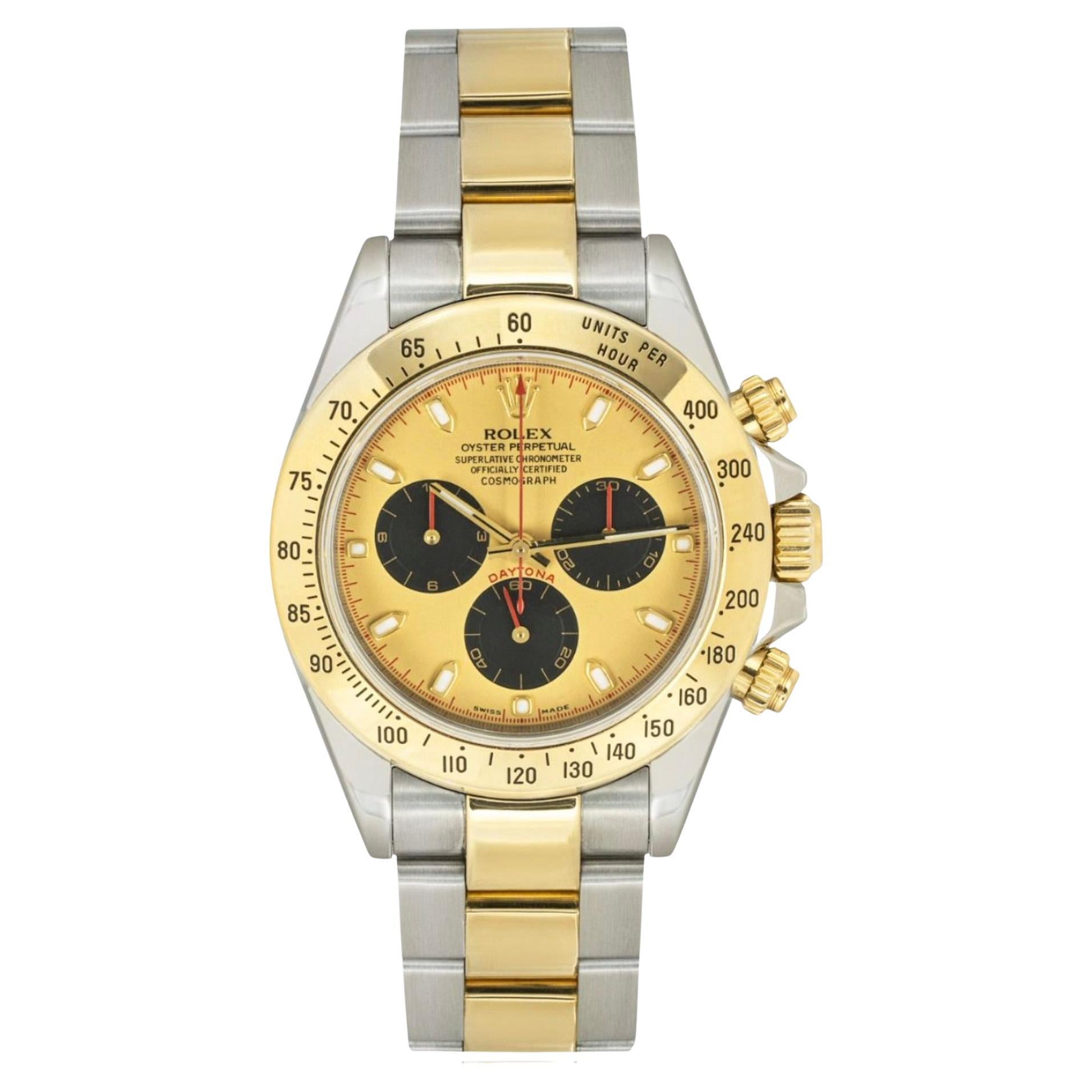A Daytona in Oystersteel and yellow gold by Rolex. Featuring a champagne dial with an engraved tachymetric scale, three black chronograph counters and pushers, the Daytona was designed to be the ultimate timing tool for endurance racing