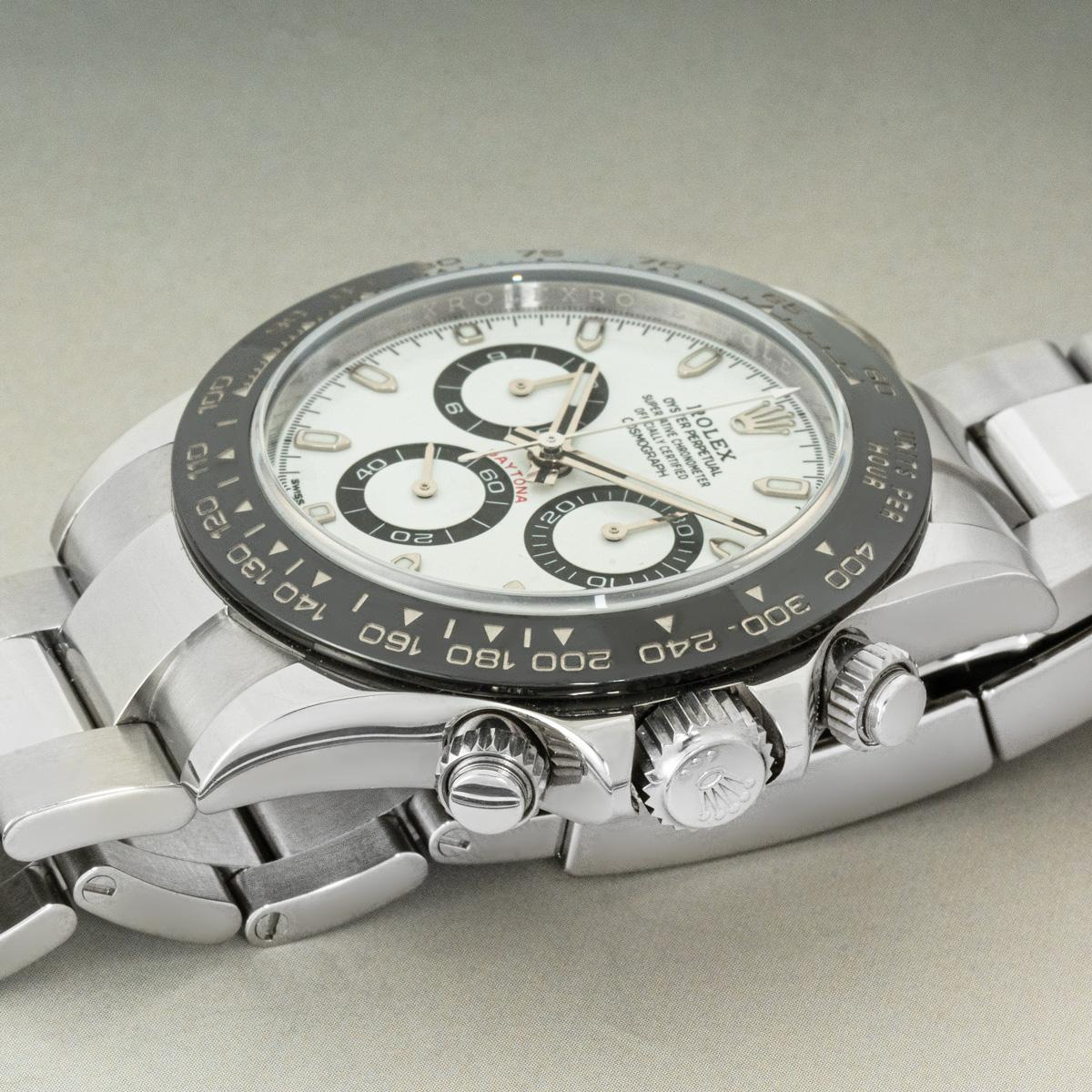 A stainless steel Daytona from Rolex with a highly desirable white dial. Featuring a black ceramic bezel with a tachymetric scale, three counters and pushers, the Daytona is the ultimate timing tool for endurance racing drivers.

The Oyster bracelet