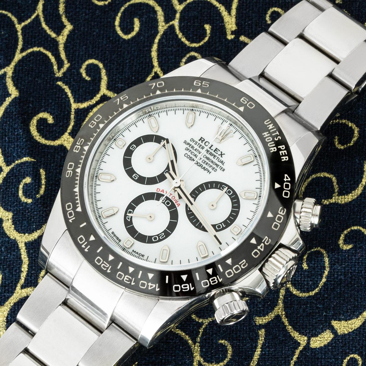 An Oystersteel Daytona from Rolex with a desirable white dial. Featuring a black ceramic bezel with a tachymetric scale, three counters and pushers, the Daytona is the ultimate timing tool for endurance racing drivers.

The Oyster bracelet is