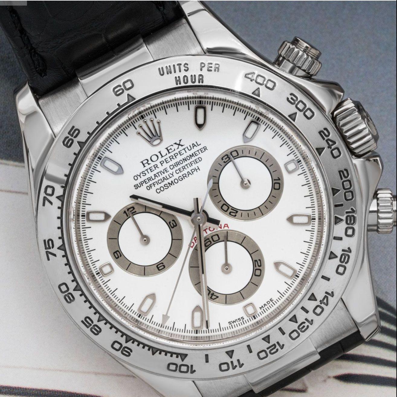 A men's 40mm Daytona crafted in white gold by Rolex.  Featuring a white dial with applied hour markers and a white gold bezel that features a tachymetric scale, three counters, and pushers; the Daytona was produced to be the ultimate timing tool for
