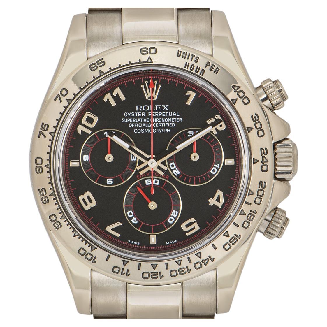 A white gold Daytona from Rolex, featuring a black racing dial with chronograph counters. With an engraved tachymetric scale, three counters and pushers, the Daytona was designed to be the ultimate timing tool for endurance racing drivers.

The