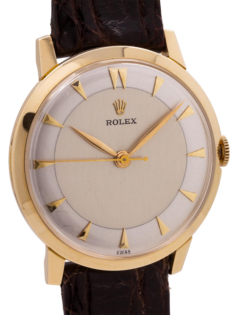
Rolex 14K YG manual wind dress model circa 1960. Featuring a 33mm snap back case with the smooth bezel, and with low dome acrylic crystal. With beautiful condition restored two tone silver dial with applied gold dagger style indexes and Rolex logo,