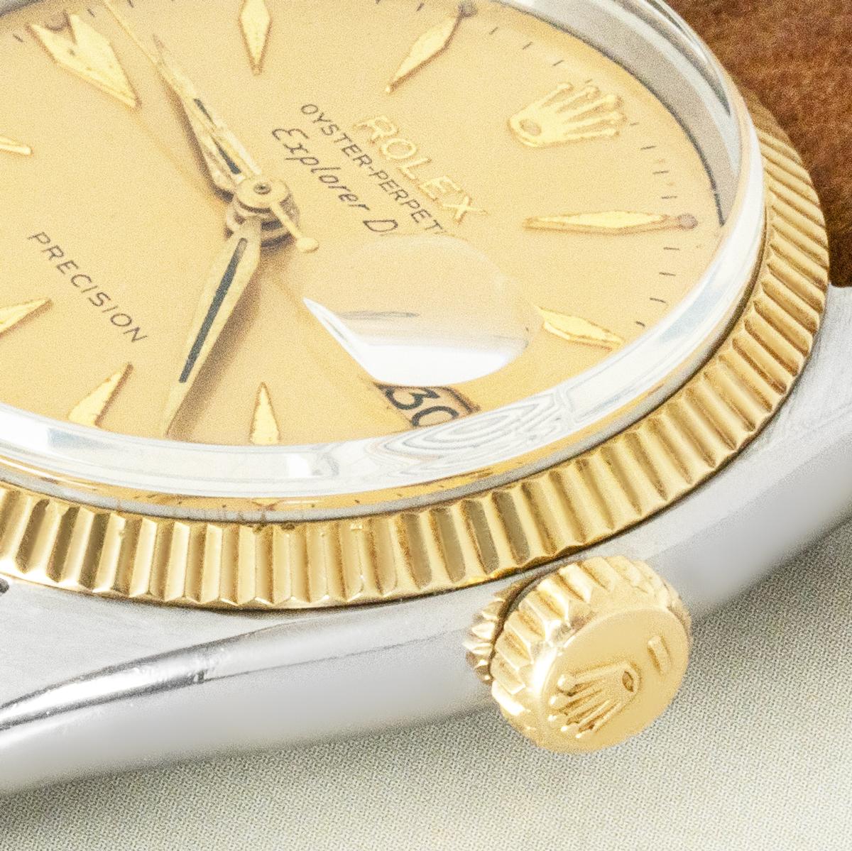 A vintage stainless steel and yellow gold Rolex Explorer Date ref. 5701 automatic movement wristwatch. Featuring well aged champagne dial with applied dagger-style hour markers.

Complemented with a fixed yellow gold flutted bezel, plastic crystal,