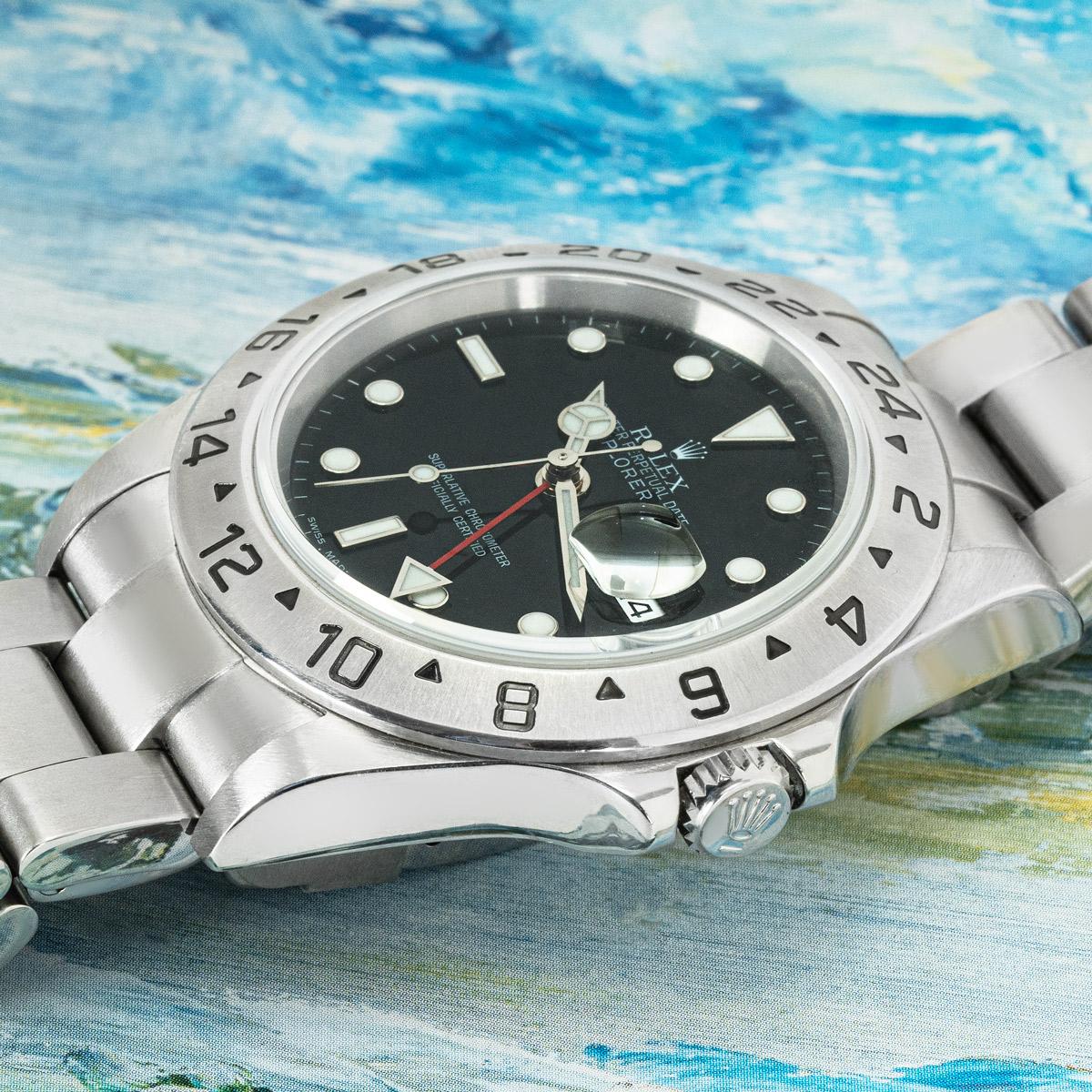 A 40mm Explorer II by Rolex in stainless steel. Features a black dial with a date aperture, a red 24-hour hand and a stainless steel fixed bezel set with a 24-hour display. Fitted with a sapphire glass, a self-winding automatic movement and a steel