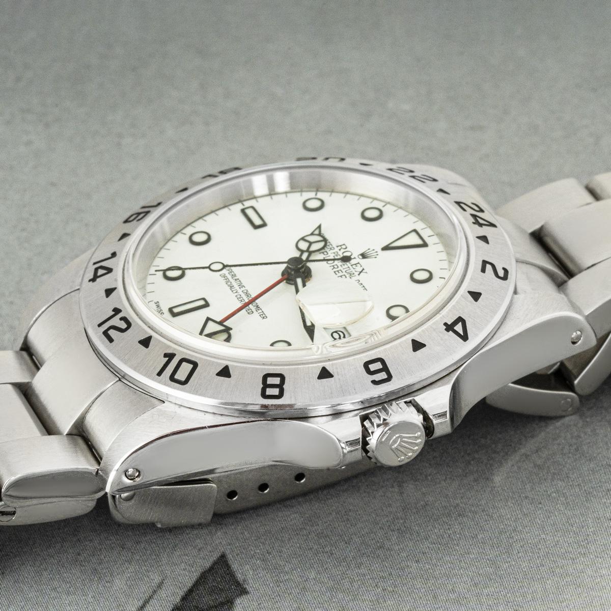 A 40mm Explorer II by Rolex in stainless steel. Features a white dial with the date, a red 24-hour hand and a fixed bezel featuring a 24-hour display. Fitted with sapphire crystal, a self-winding automatic movement and an Oyster bracelet brought