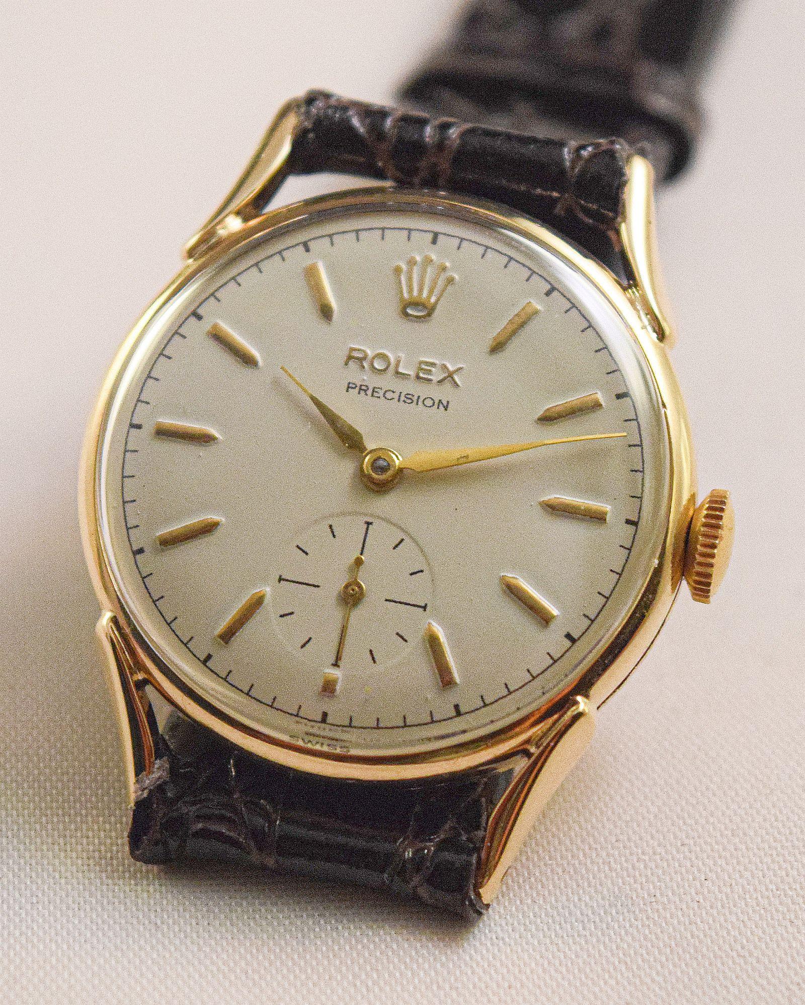 Rolex another lovely and very rare vintage Rolex watch.
Unusual lugs and solid Pink gold case with solid gold  fixed wire lugs.
1950's
Dial is signed Rolex Precision.
Raised gold Rolex Crown and raised gold markers'
subsidiary seconds at 6
Gold