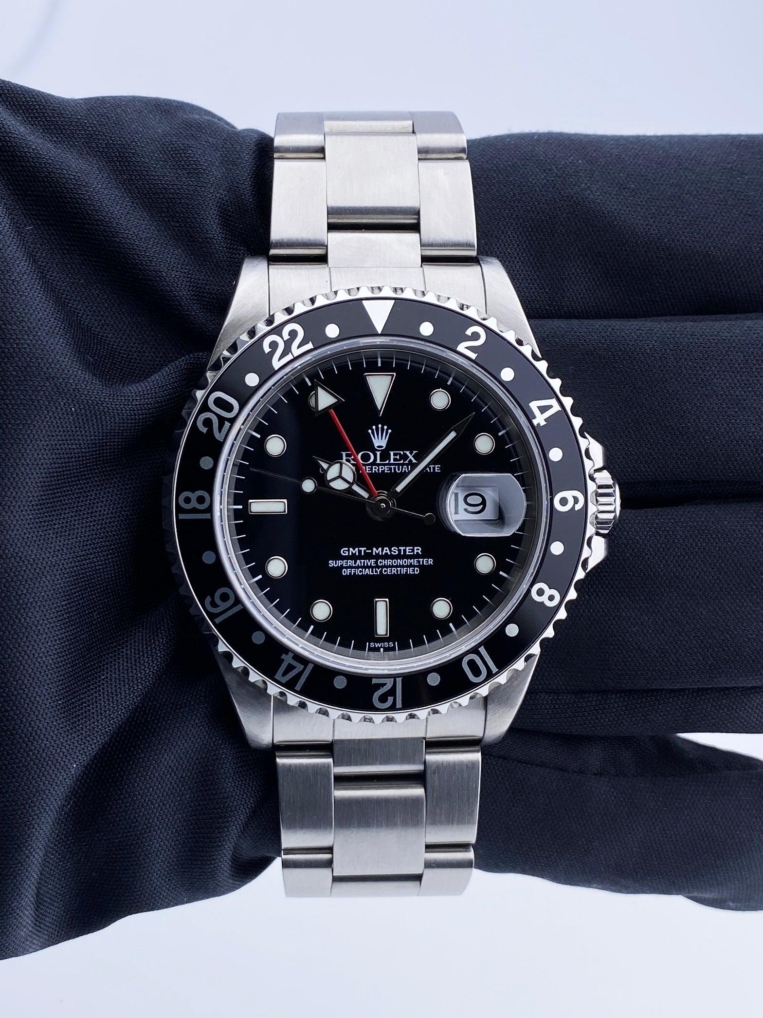 Rolex GMT-Master 16700 Mens Watch. 40mm stainless steel case. Stainless steel bidirectional bezel. Black dial with luminous steel hands and index dot hour markers. Minute markers on the outer dial. Date display at the 3 o'clock position. Stainless