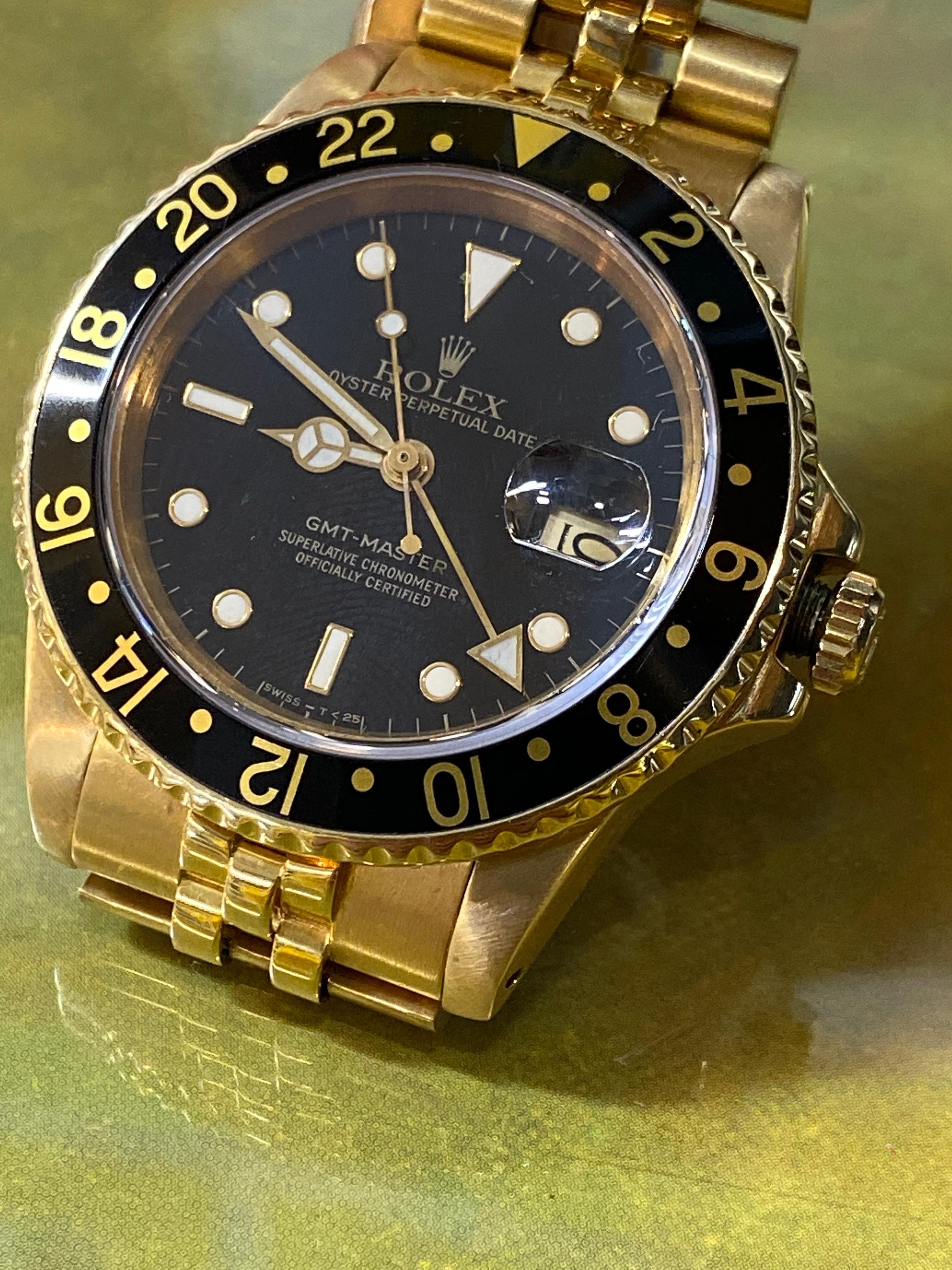 ROLEX GMT MASTER REF. #16758 18K YG W/ BLACK BEZEL AND DIAL RARE VINTAGE 1981 MODEL

ITEM DESCRIPTION: 
The Rolex GMT is the jet-setting icon of the Rolex sports watch family. The history of this sophisticated, versatile style dates back to 1954