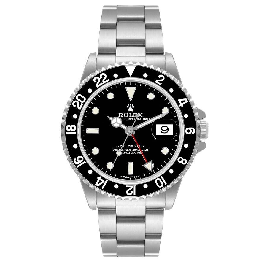 Rolex GMT Master Black Bezel Automatic Steel Mens Watch 16700 Box Papers. Officially certified chronometer automatic self-winding movement. Stainless steel case 40.0 mm in diameter. Rolex logo on the crown. Bidirectional rotating bezel with a