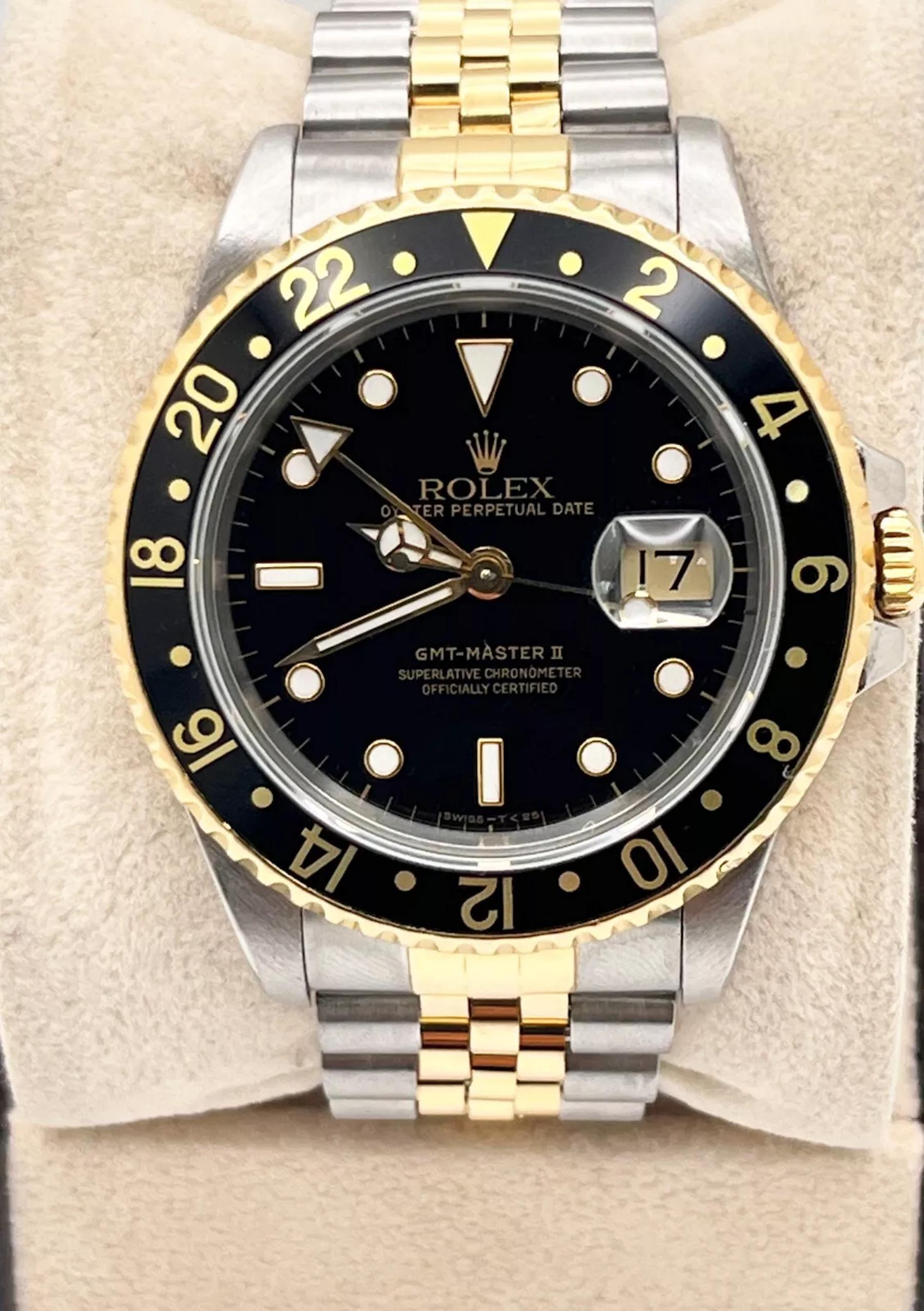 Style Number: 16713
Serial: X294***
Year: 1991
Model: Rolex GMT Master II 
Case Material: Stainless Steel 
Band: 18K Yellow Gold & Stainless Steel
Bezel: Black Bezel 
Dial: Black Dial 
Face: Sapphire Crystal 
Case Size: 40mm 
Includes: 
-Elegant