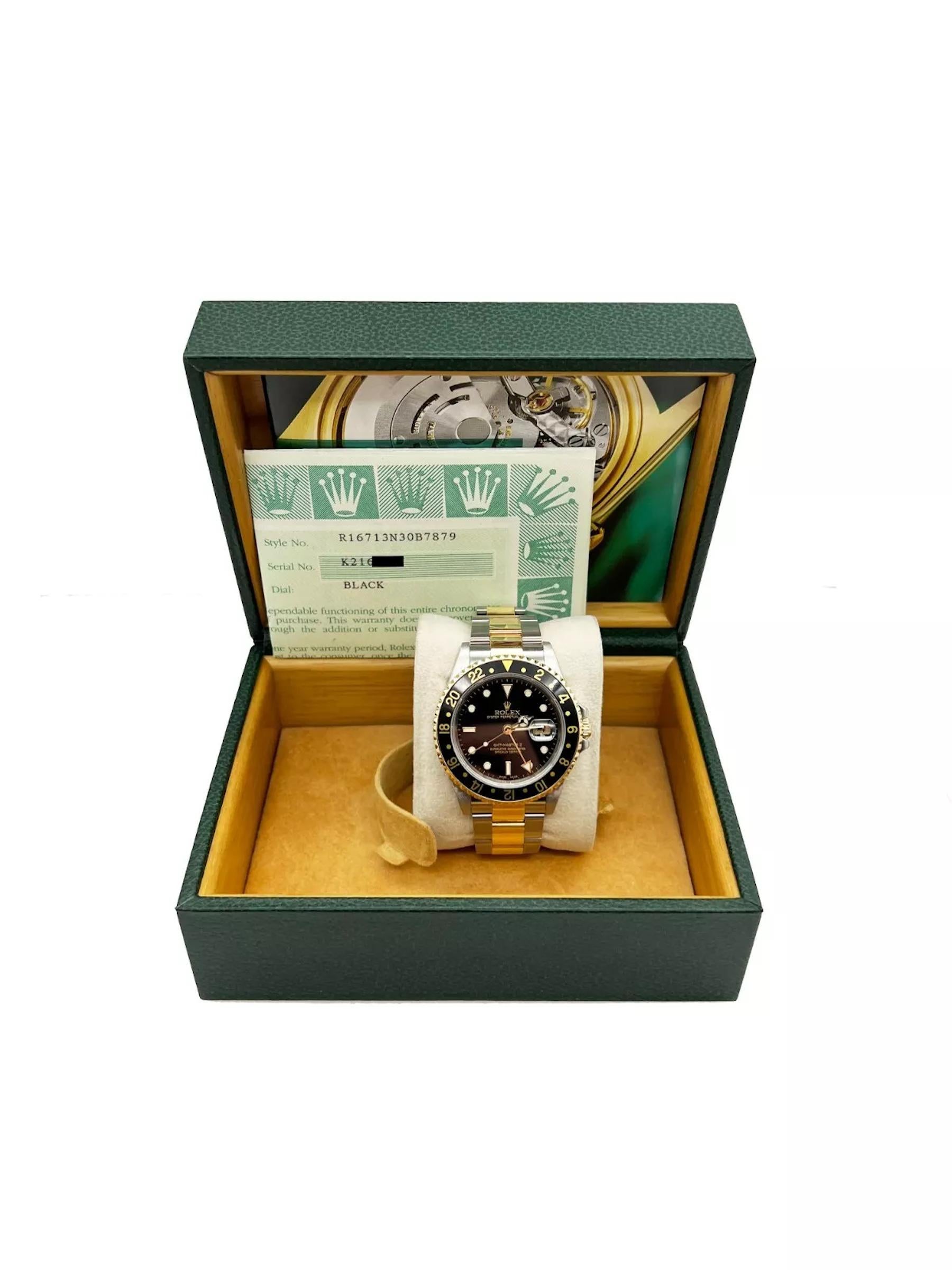 Style Number: 16713
Serial: K216***
Year: 2002
Model: Rolex GMT Master II 
Case Material: Stainless Steel 
Band: 18K Yellow Gold & Stainless Steel
Bezel: Black
Dial: Black
Face: Sapphire Crystal
Case Size: 40mm 
Includes: 
-Rolex Box &