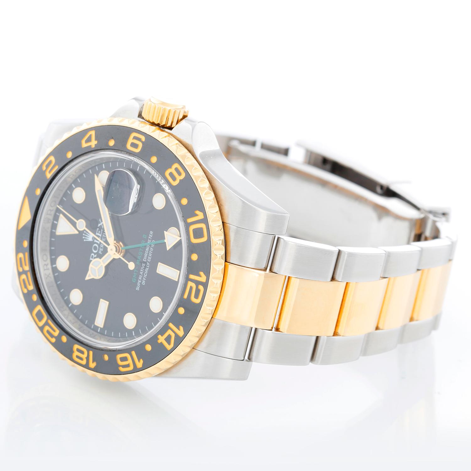 Rolex GMT-Master II 2-Tone Men's Watch 116713 with Green GMT hand - Automatic winding, 31 jewels, Quickset, sapphire crystal. Stainless steel case with 18k yellow gold bezel (40mm diameter). Black dial with luminous style markers. Stainless steel &