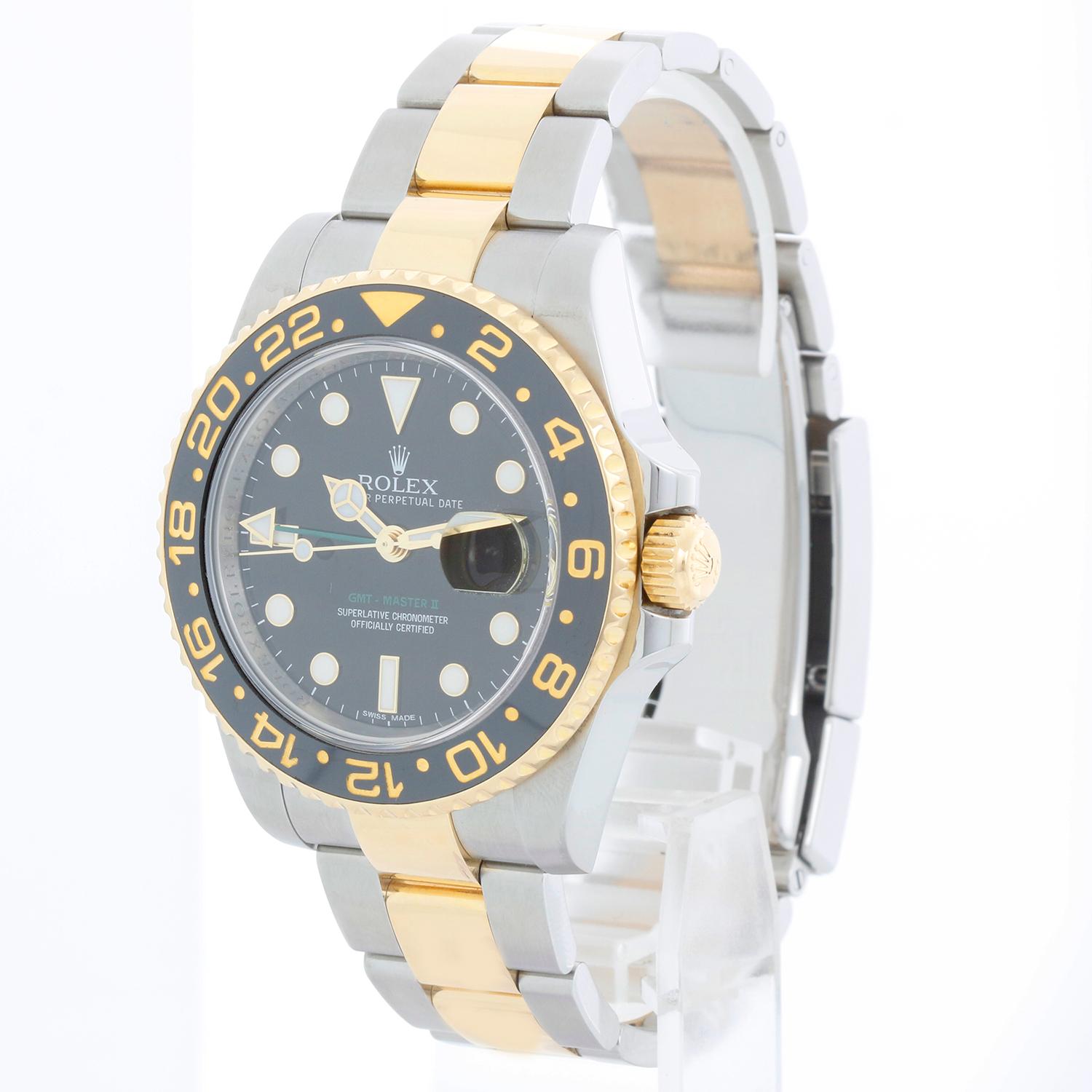 Rolex GMT-Master II 2-Tone Men's Watch 116713 with Green GMT hand - Automatic winding, 31 jewels, Quickset, sapphire crystal. Stainless steel case with 18k yellow gold bezel (40mm diameter). Black dial with luminous style markers. Stainless steel &