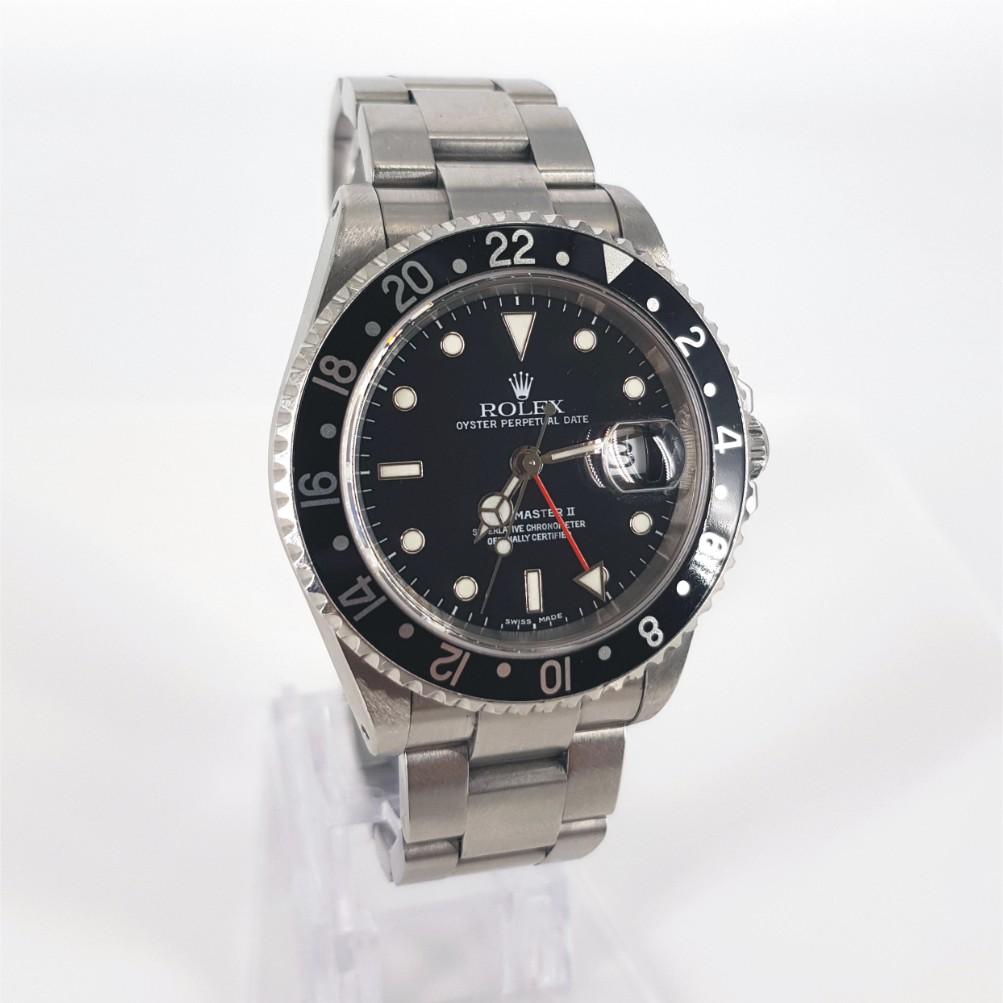 Rolex Oyster Perpetual Date GMT Master II Watch - Automatic in Excellent condition. 
Model Number: 16710 & Serial Number: Y330352 
Year: 1991 - 2009
Stainless Steel Case measuring 40mm with a Black Dial & Stainless Steel Strap measuring 51mm with