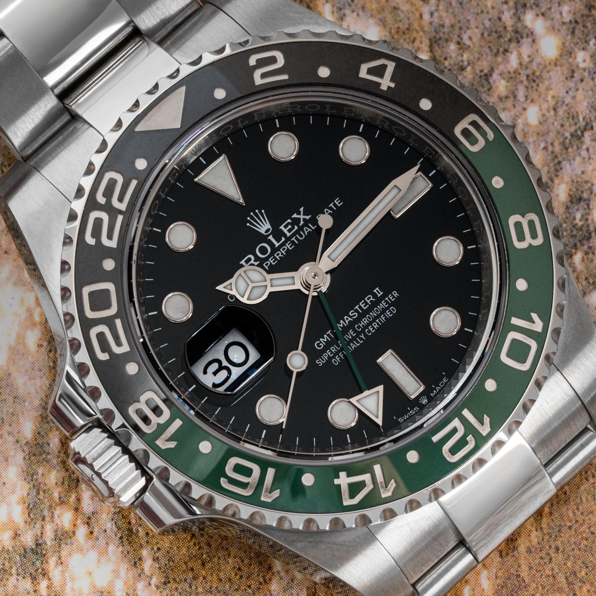 A GMT-Master II Sprite Left Handed by Rolex crafted in stainless steel. Featuring a black dial with a green time zone hand. The green and black bidirectional rotatable bezel features a 24-hour display and is presented with a distinctive crown set on
