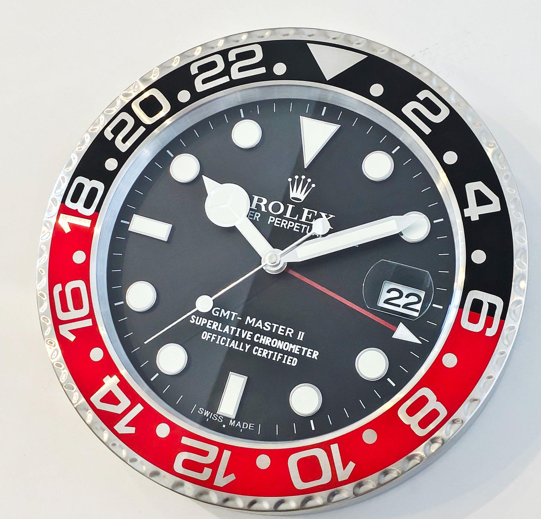 GMT Master II Store Display Wall Clock by Rolex.

This is a very decorative wall clock depicting the Rolex GMT Master II wristwatch. The wall clock has been crafted in Switzerland with parts made up in stainless steel, aluminum and glass. All