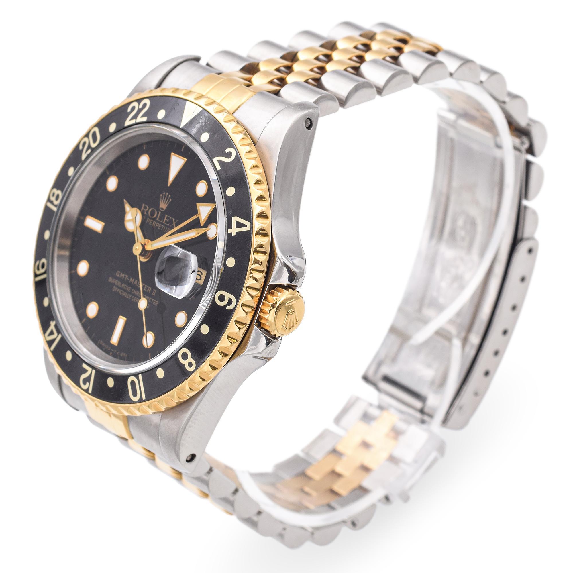 A true icon of travel and luxury, this Rolex GMT-Master II embodies timeless sophistication and robust functionality. Crafted from stainless steel and 18k yellow gold, this two-tone model features a black dial with luminous hour markers and Mercedes