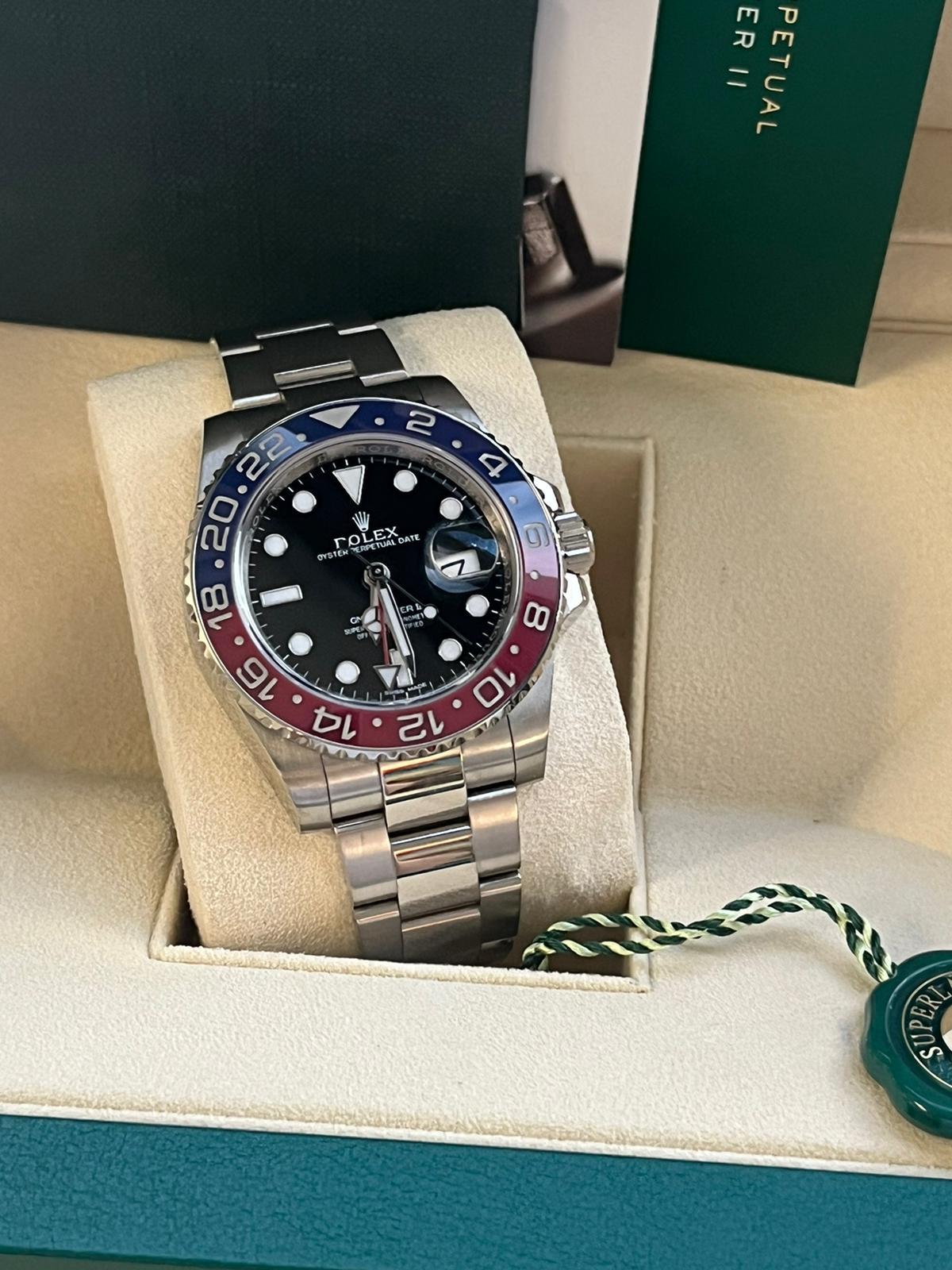 Rolex GMT Master II White Gold Pepsi Bezel Mens Watch 116719. This timepiece is powered by the self-winding 3285 calibers with a 70-hour power reserve, Chronometer with an 18K white gold case 40 mm in diameter. Rolex logo on a crown. 18K white gold