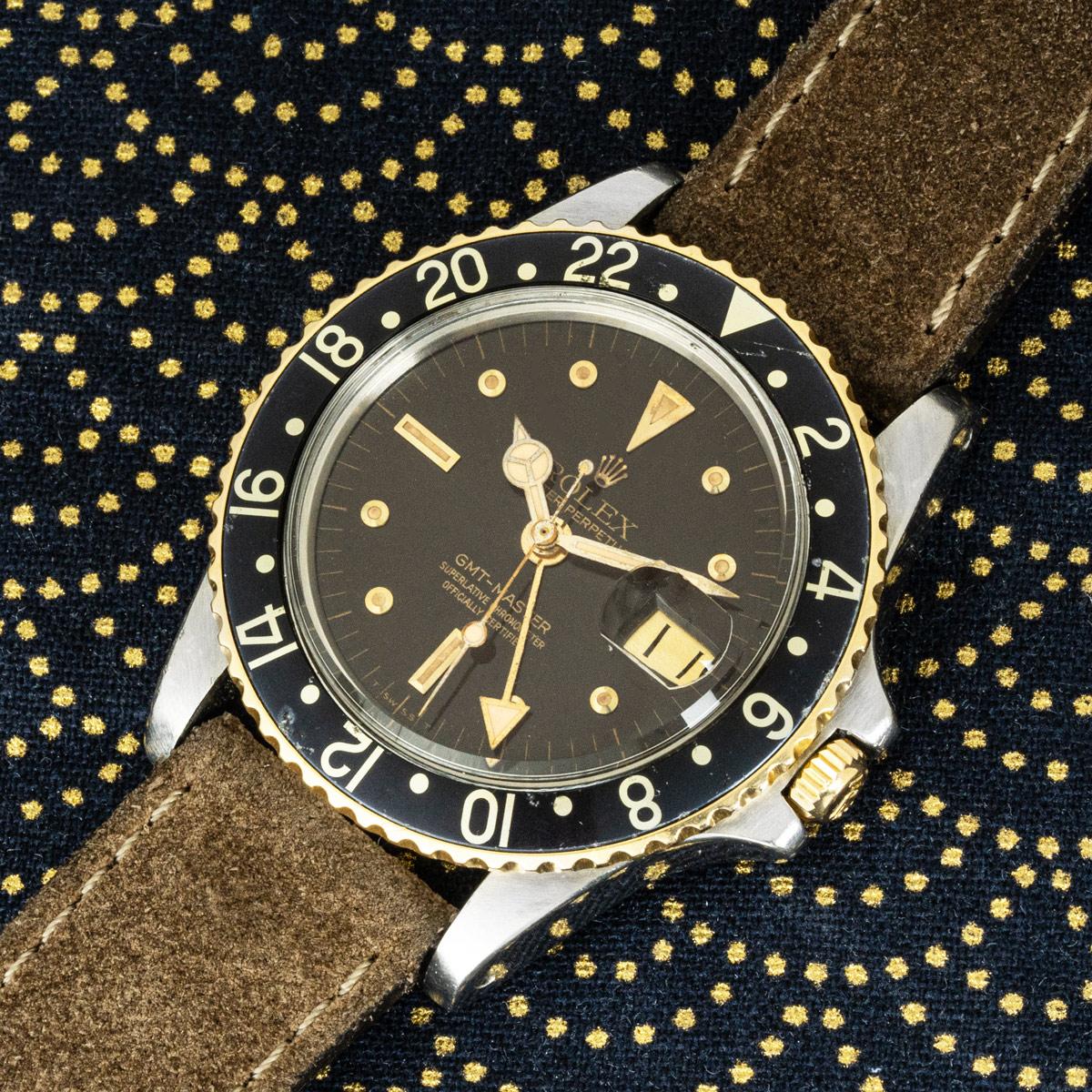 A rare vintage Rolex GMT-Master reference 1675, dating to circa 1978. This remarkable example showcases a black tropical ‘nipple’ dial that has aged to a warm, rich patina over time. The dial is enhanced by applied gold hour markers and a date