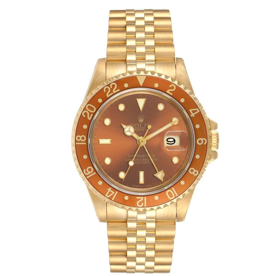 Rolex GMT Master Rootbeer 18K Yellow Gold Vintage Mens Watch 16718. Officially certified chronometer self-winding movement. 18K yellow gold case 40.0 mm in diameter. Rolex logo on a crown. 18k yellow gold bidirectional rotating bezel with a special