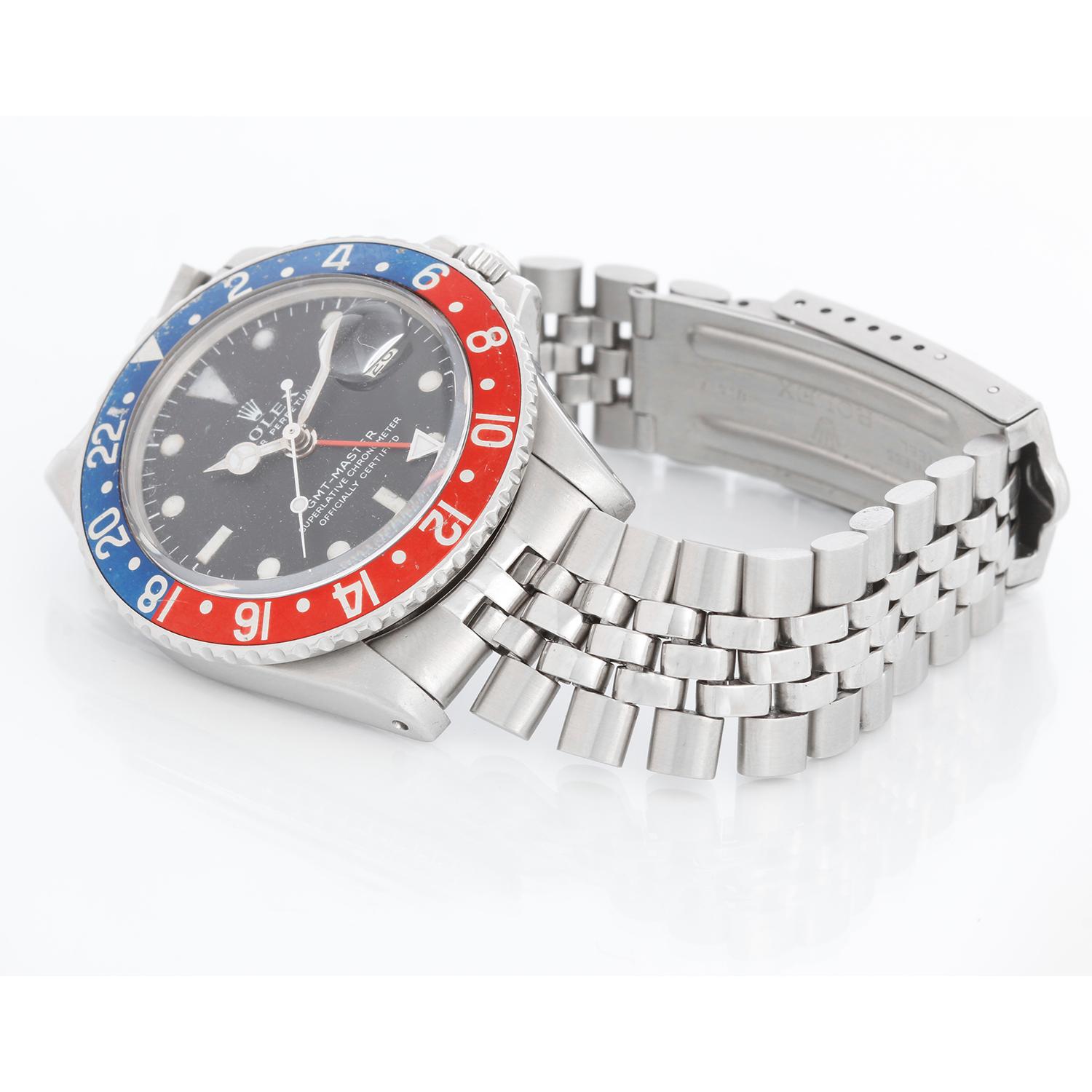 Rolex GMT-Master Stainless Steel Men's Watch 1675 - Automatic winding. Stainless steel case, rotating bezel with original red & blue (pepsi) insert  (40mm) . Black dial . Stainless steel Rolex USA Jubilee bracelet. Pre-owned with Rolex box. 

To