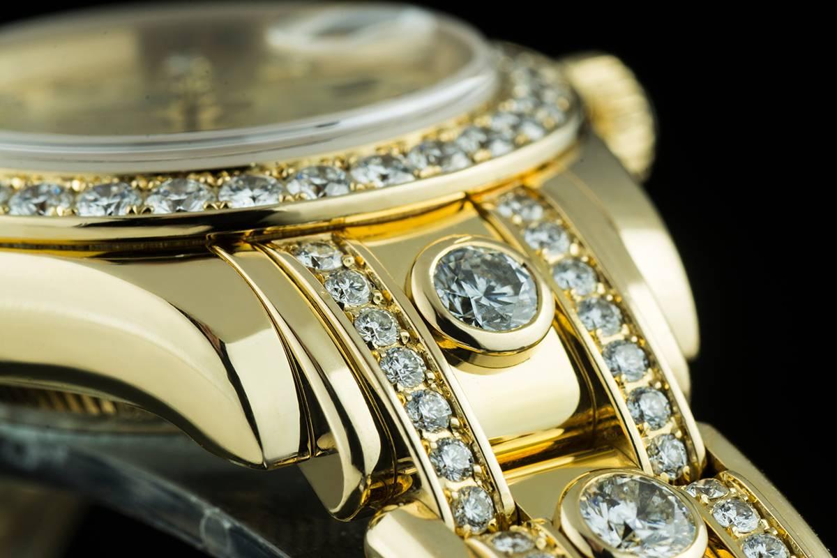 A Gold Oyster Perpetual Pearlmaster Datejust Ladies Wristwatch, champagne dial with 10 applied round brilliant cut hour markers, a fixed gold bezel set with approximately 32 round brilliant cut diamonds (~1.45ct), gold lugs each set with 15 round