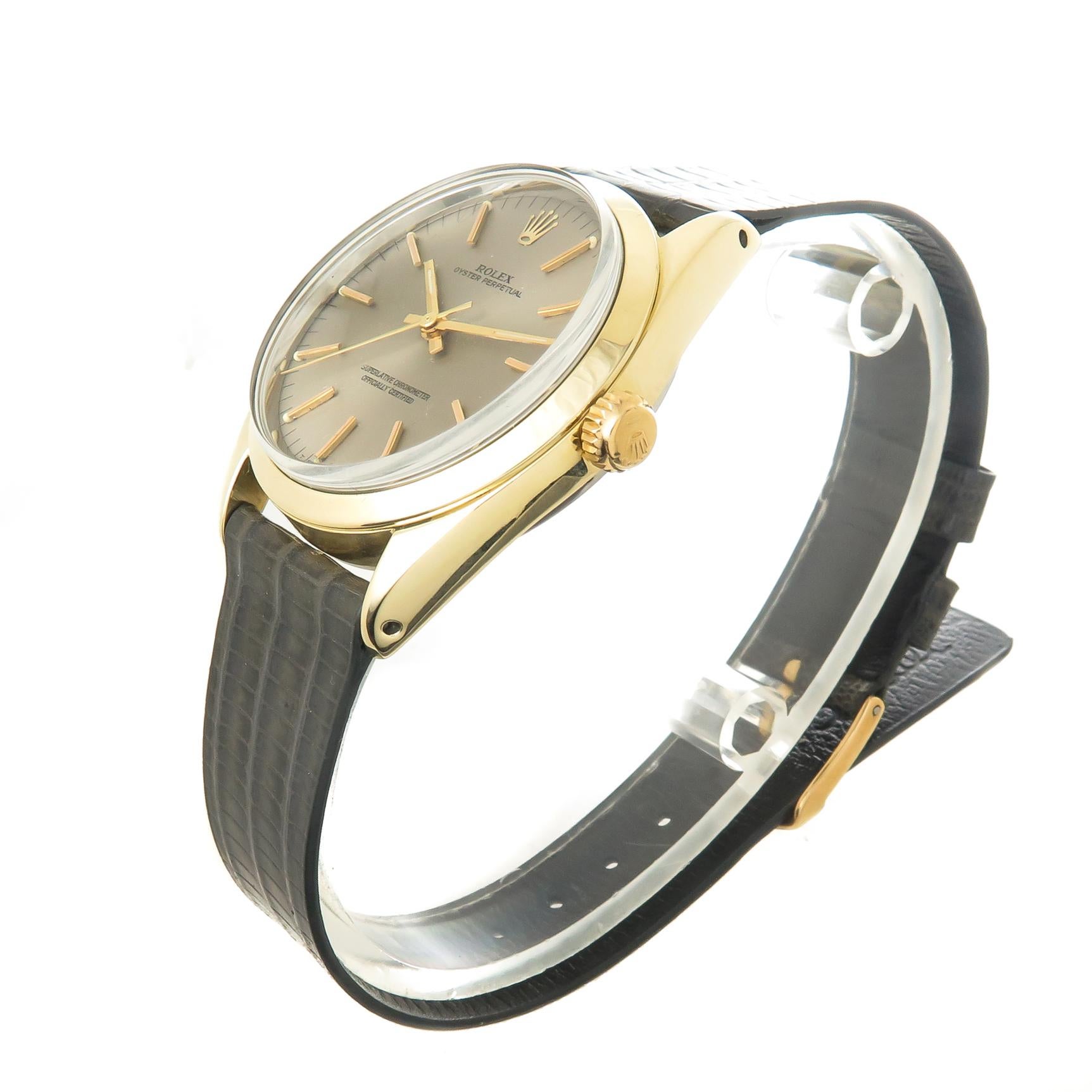 Circa 1967 Rolex Oyster Perpetual Reference 1024, 34 MM Gold Shell case with Stainless Steel Back, Caliber 1570 Automatic, self winding movement. Light Silver Gray dial with raised Gold markers, Gold markers and a sweep seconds hand. New Gray Lizard